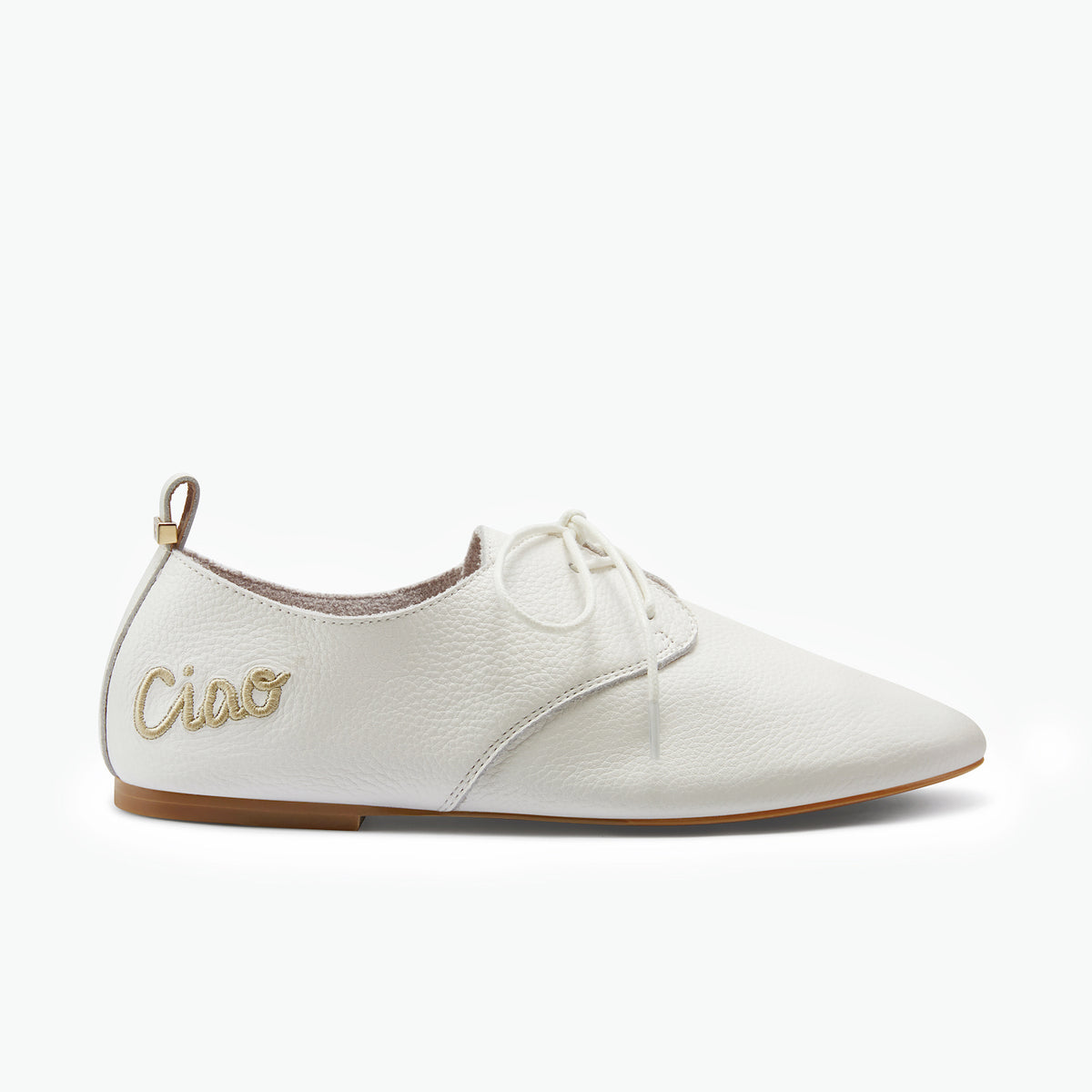 White soft lace-up flat shoe in white pebble leather with Ciao in gold embroidery on side.