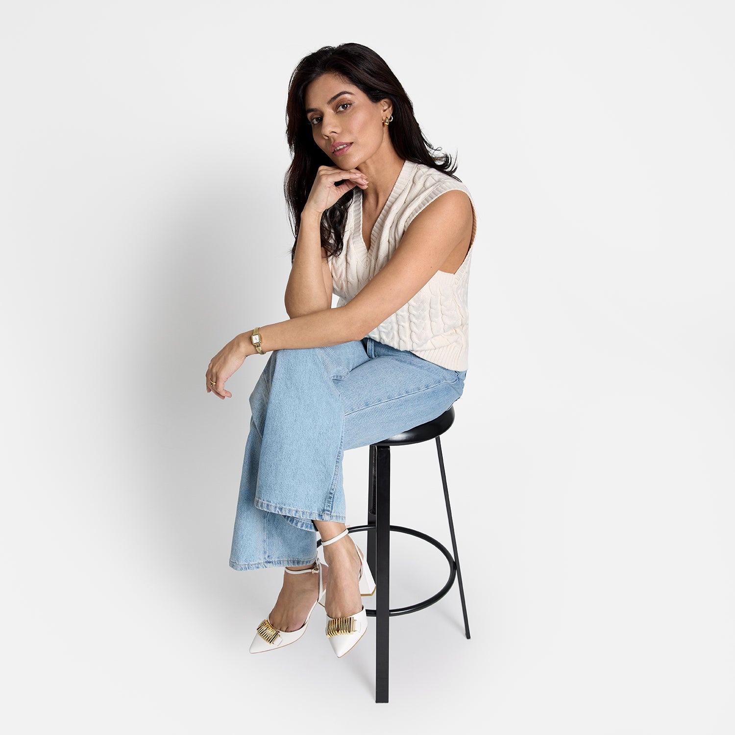 Model wearing Austin heel with white leather upper and slip proof soles.