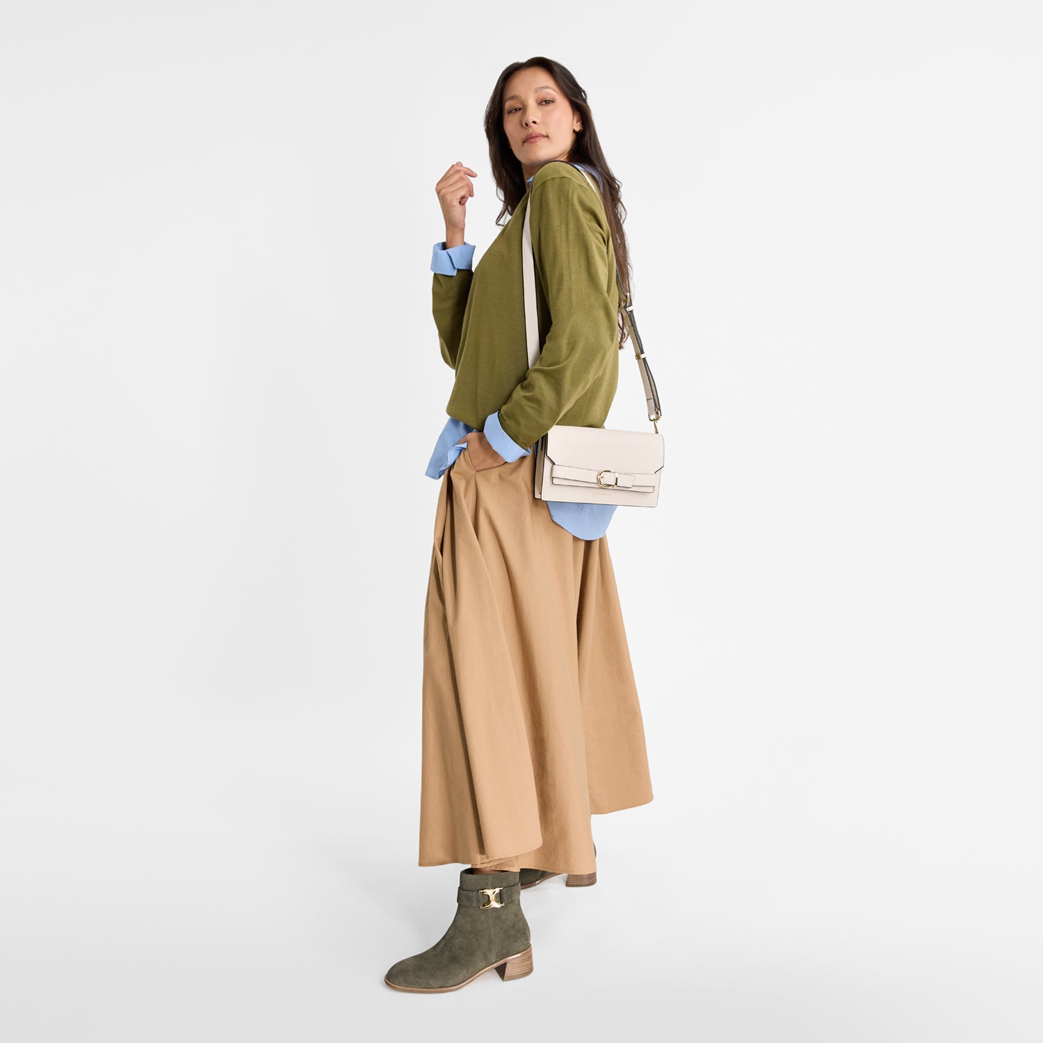 Model wearing Nicole Rebstock green suede ankle boots.