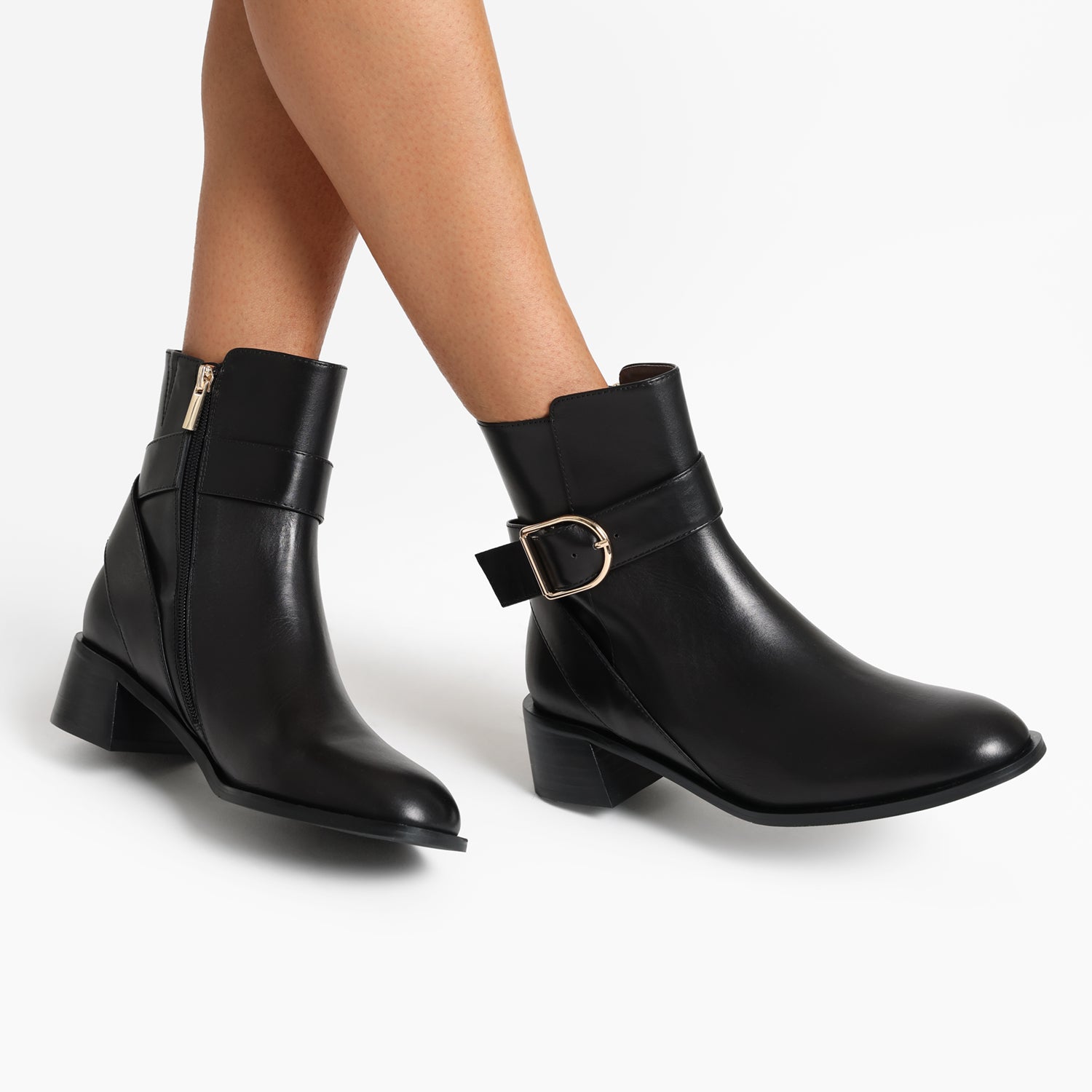 Bologna black leather ankle boot on women's feet.