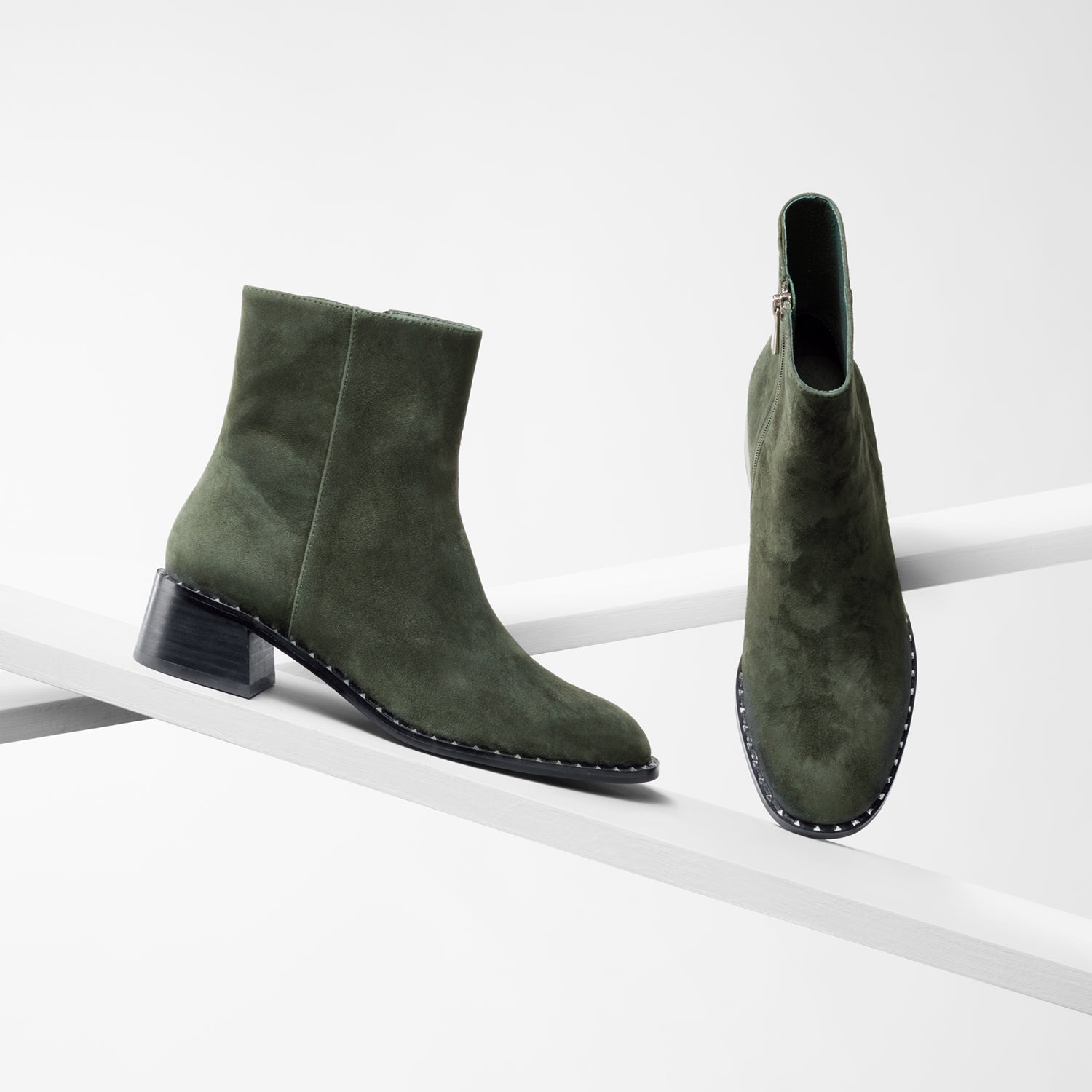 Bordeaux dark moss suede ankle boot with studs on planks showing all sides.