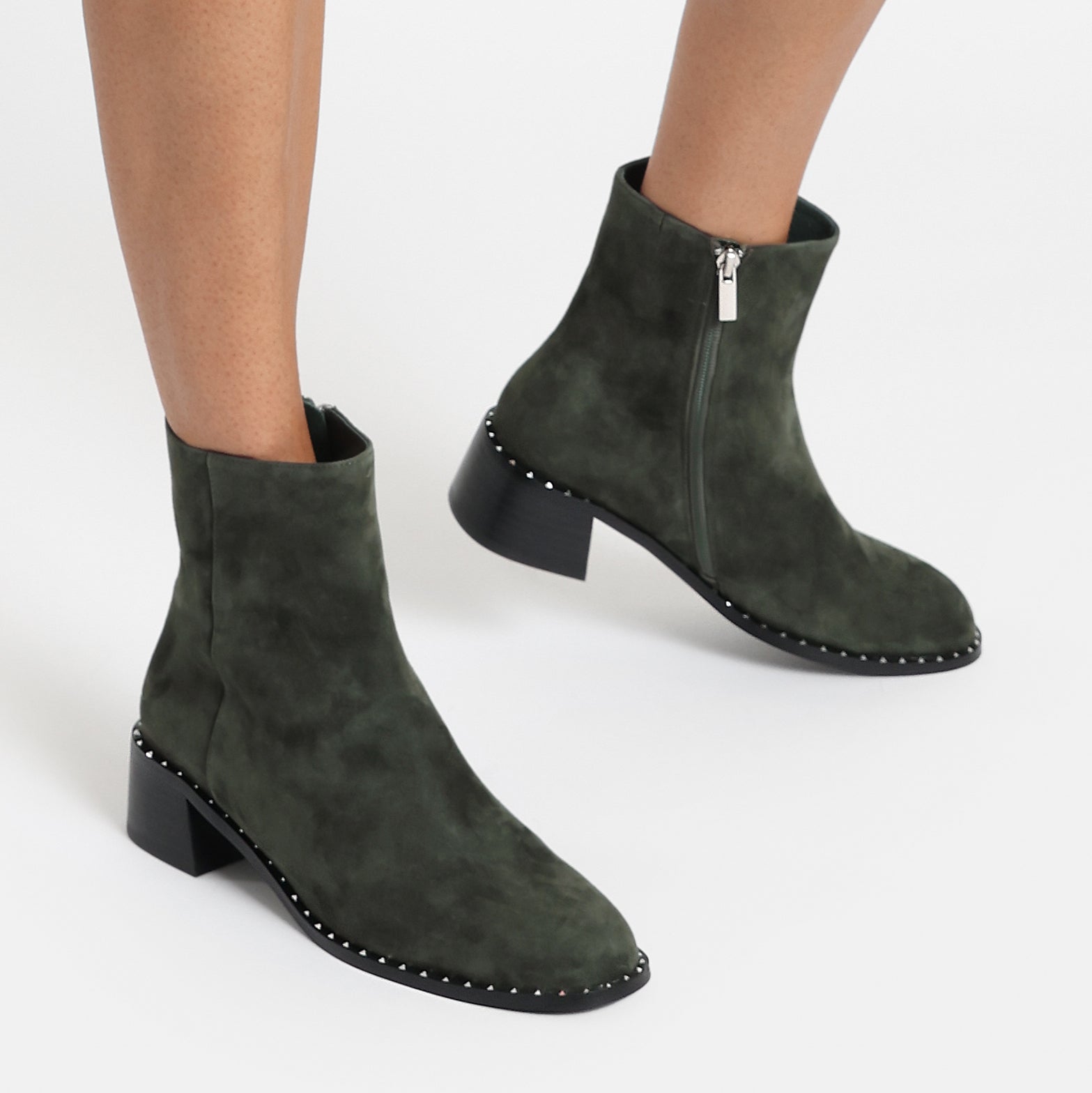 Bordeaux dark moss suede ankle boot on women's feet.