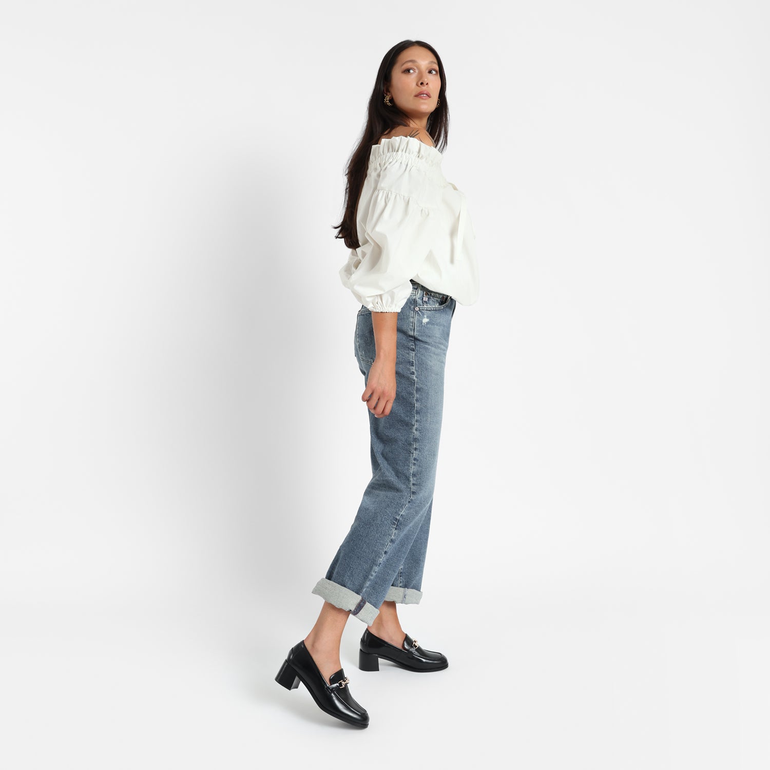 Woman wears Bremen Loafer in black leather with 4.5cm heel.