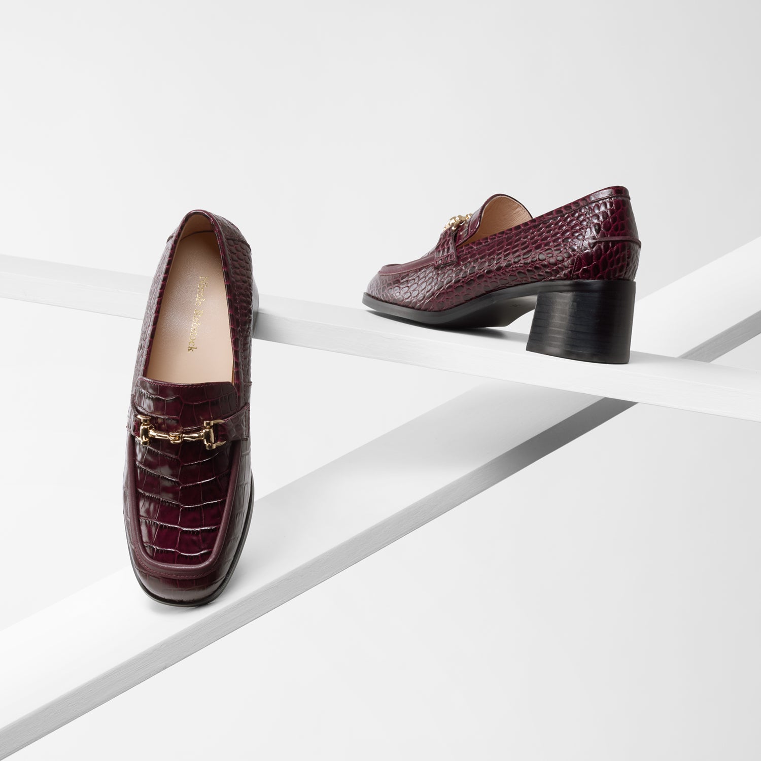 Limited Edition Bremen Loafer in ox blood burgundy. 4.5cm block heel. Gold chain detailing.