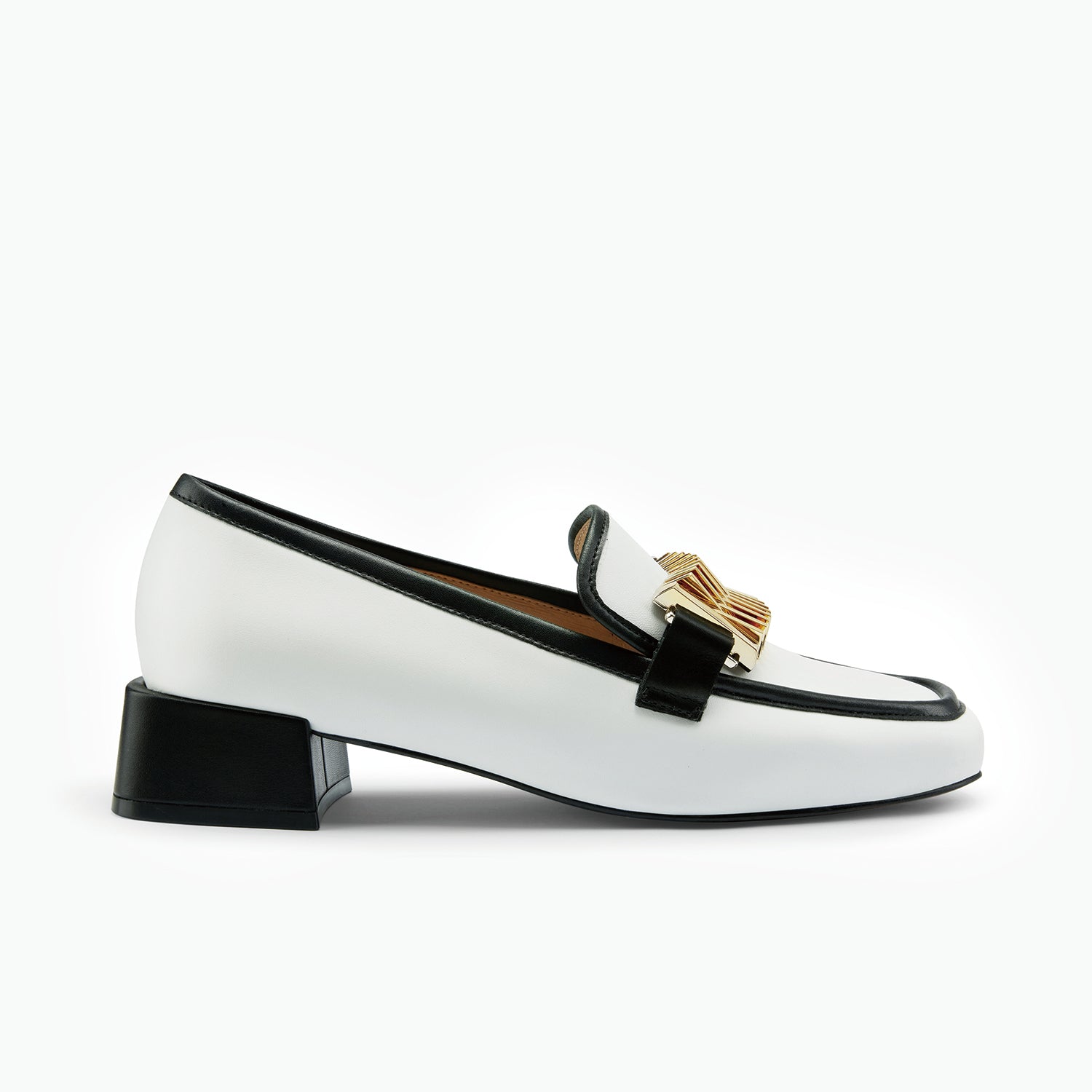White loafer with black heel and gold buckle on a white background