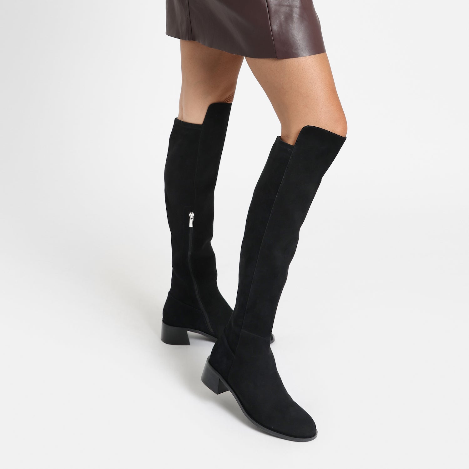 Close up of Brussels long boot in black suede. Featuring silver zip and low block heel.