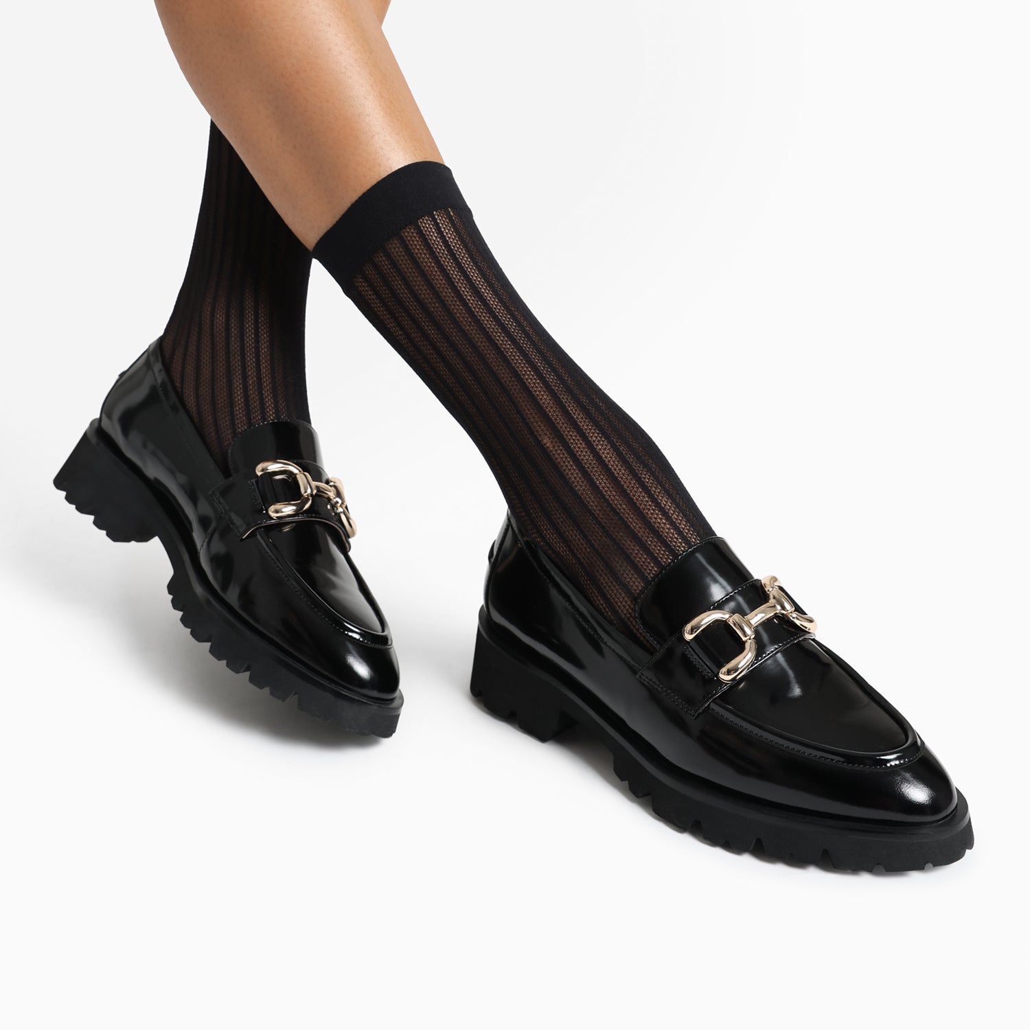 California black leather loafer worn by model.