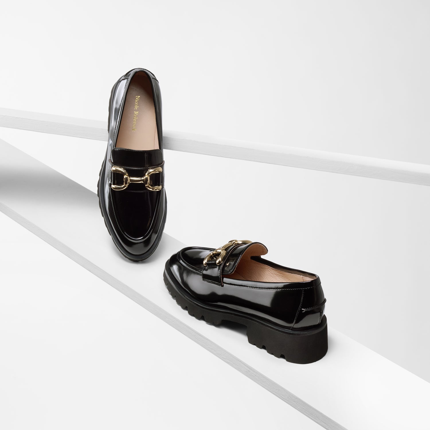 California black oiled leather loafer side and front view with gold metal buckle and chunky black outsole.