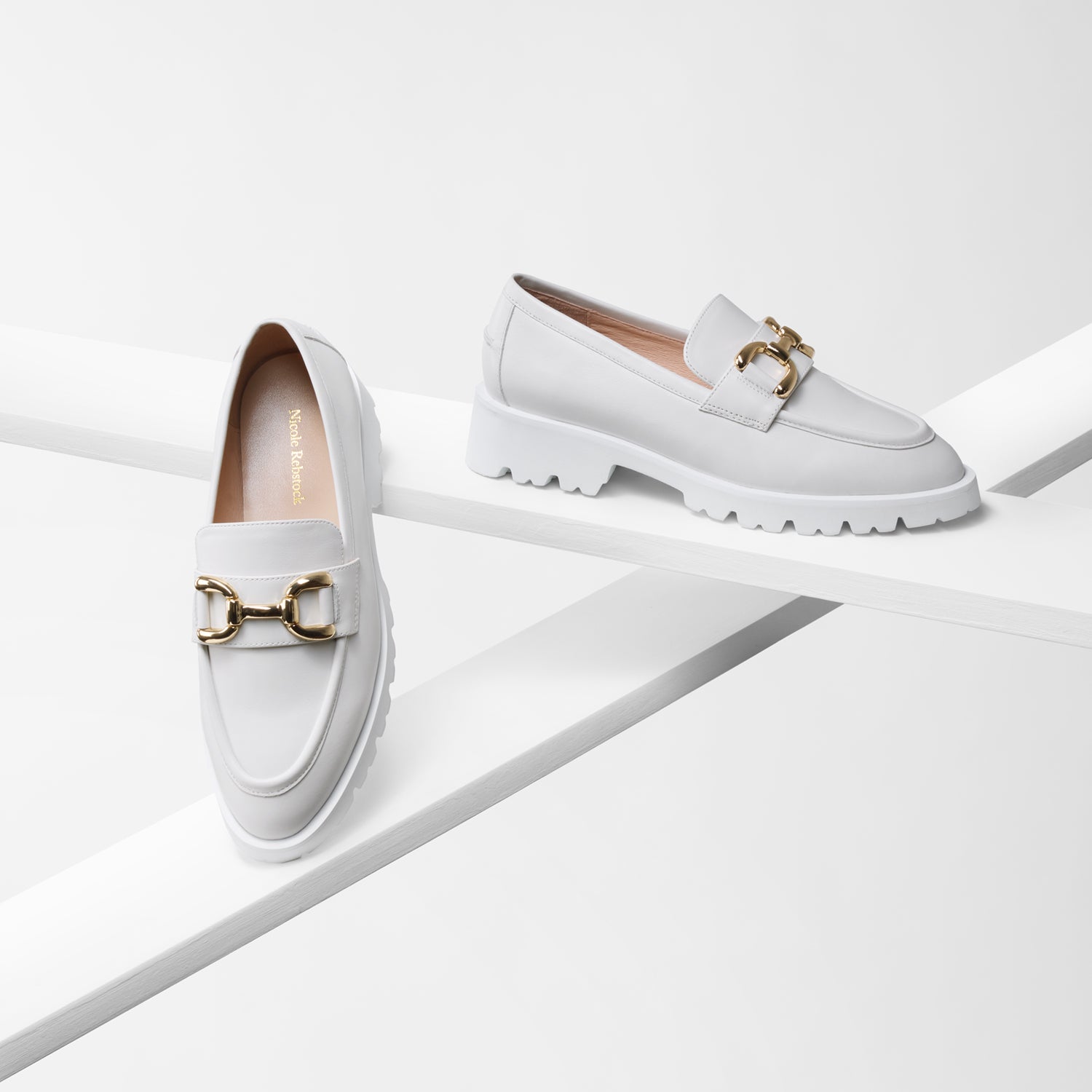 California off-white loafer side and front view with gold metal buckle and chunky white outsole.