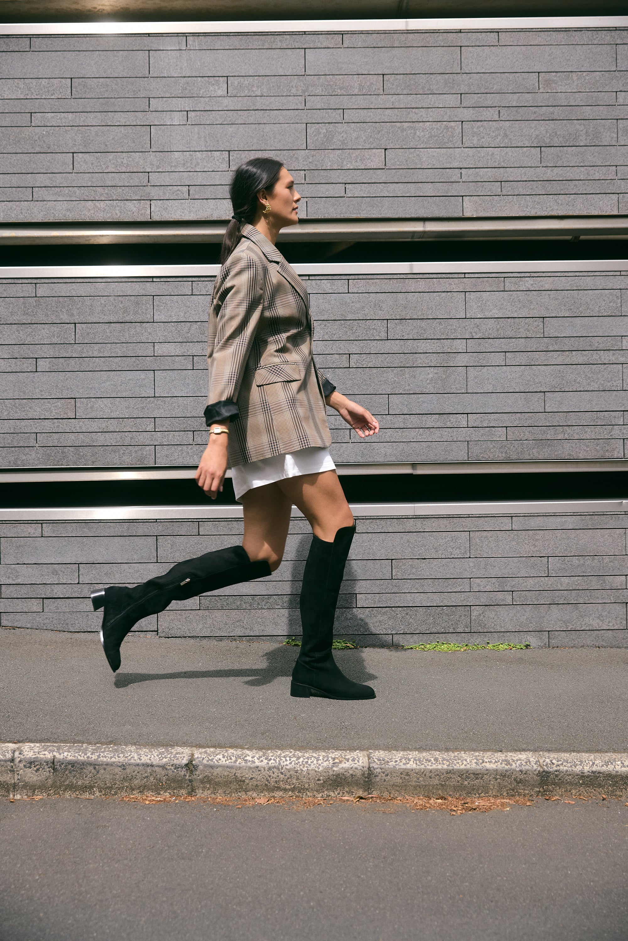 Woman walks in Brussels Knee High Boot.