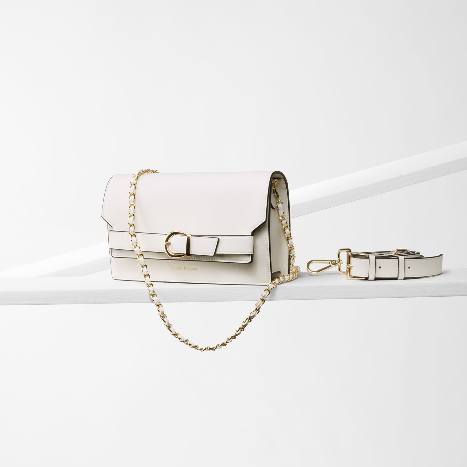 Medium size Capri cream clutch crossbody bag with two strap options. Leather strap and metal strap. Gold buckle.