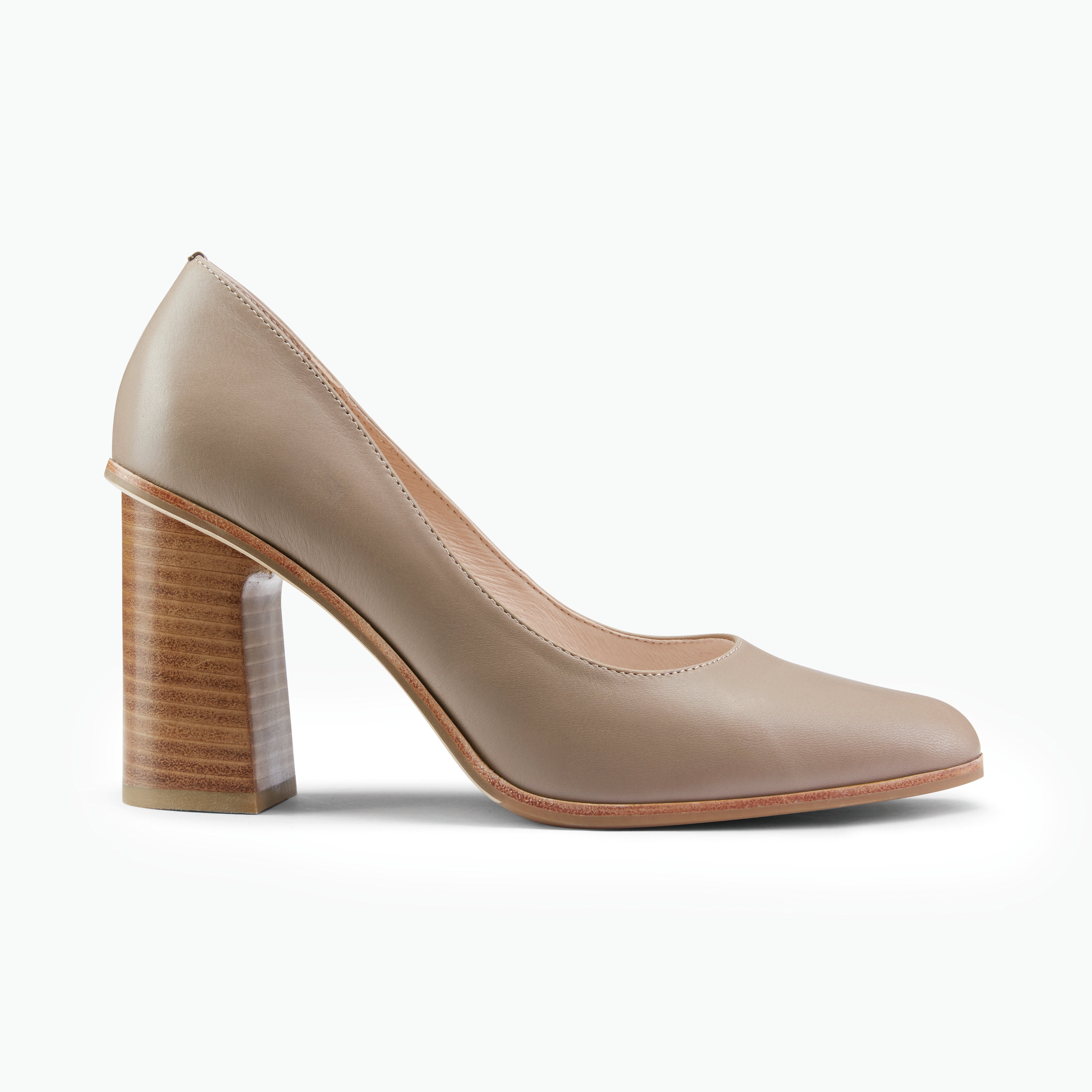 Beige high-heeled shoe with wooden heel on a white background