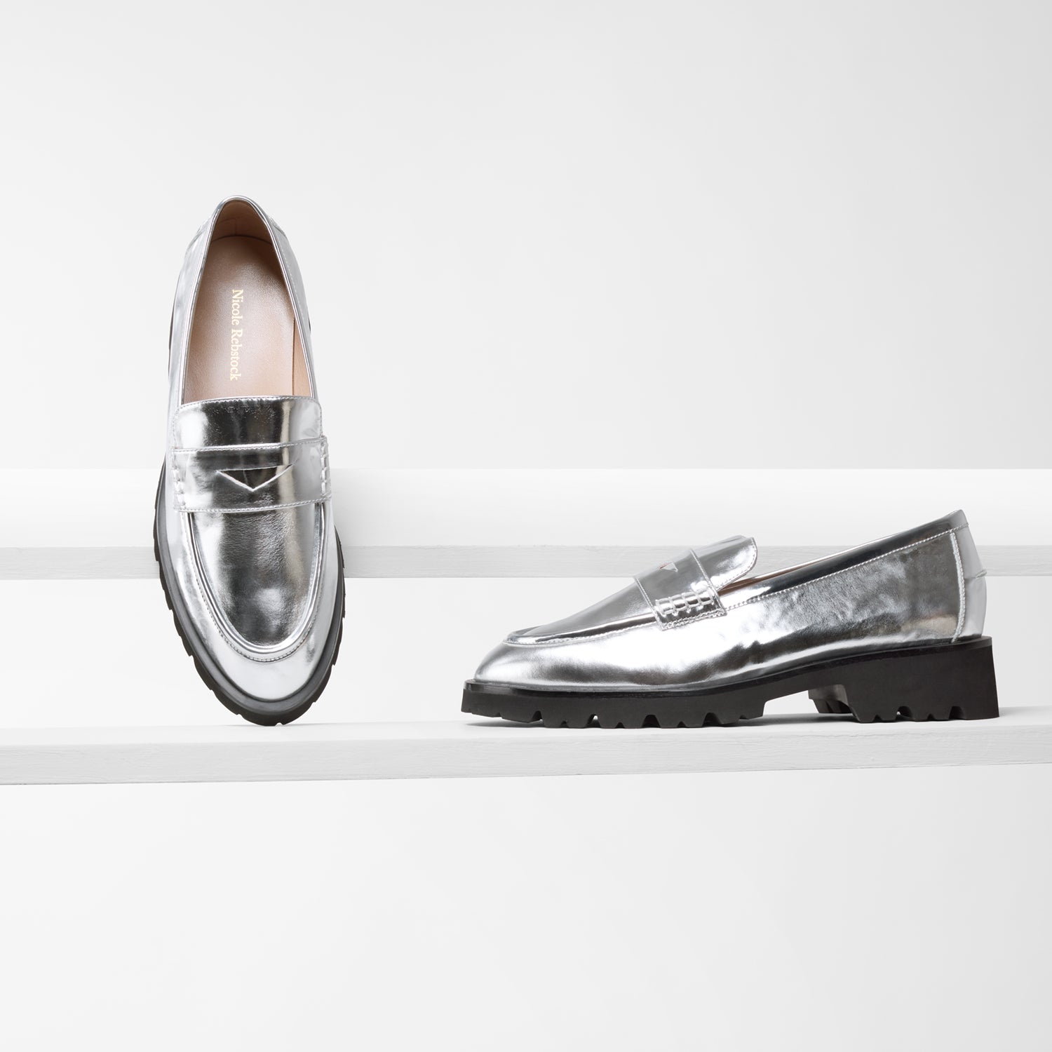 Czech Loafer in silver on planks showing different angles of the shoe. Chunky thick tread black outsole.