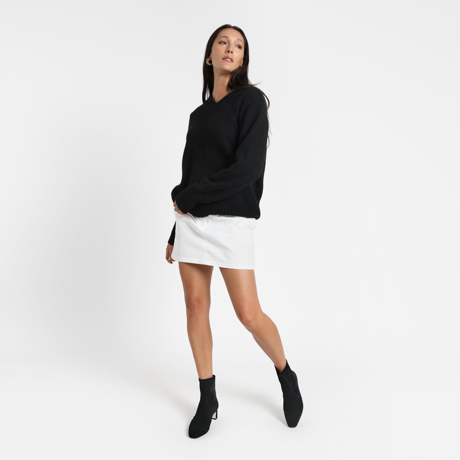 Demi black suede ankle boot worn by model.