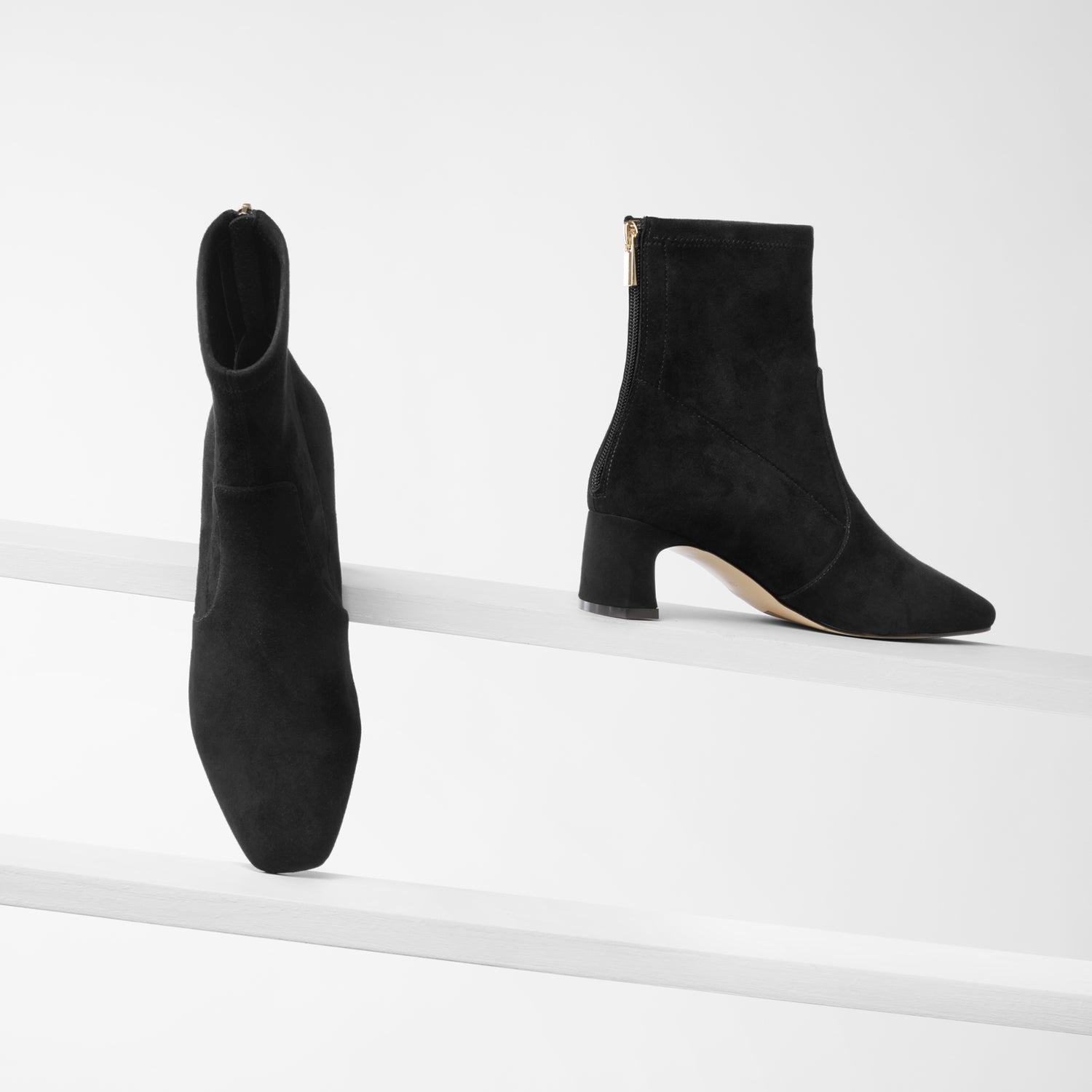 Demi black suede ankle boot with square toe on planks showing all sides
