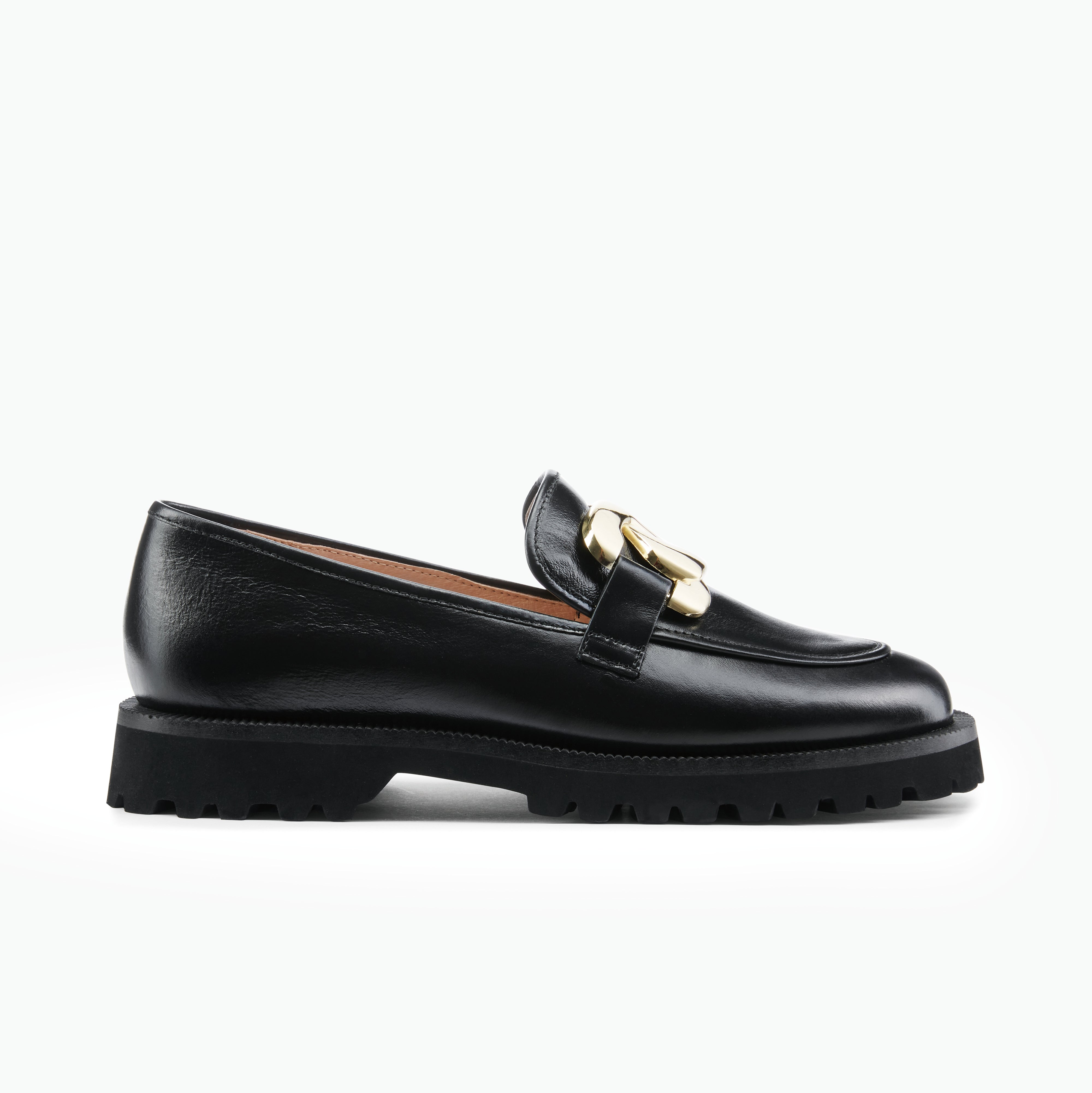 Black loafer with gold buckle on a white background