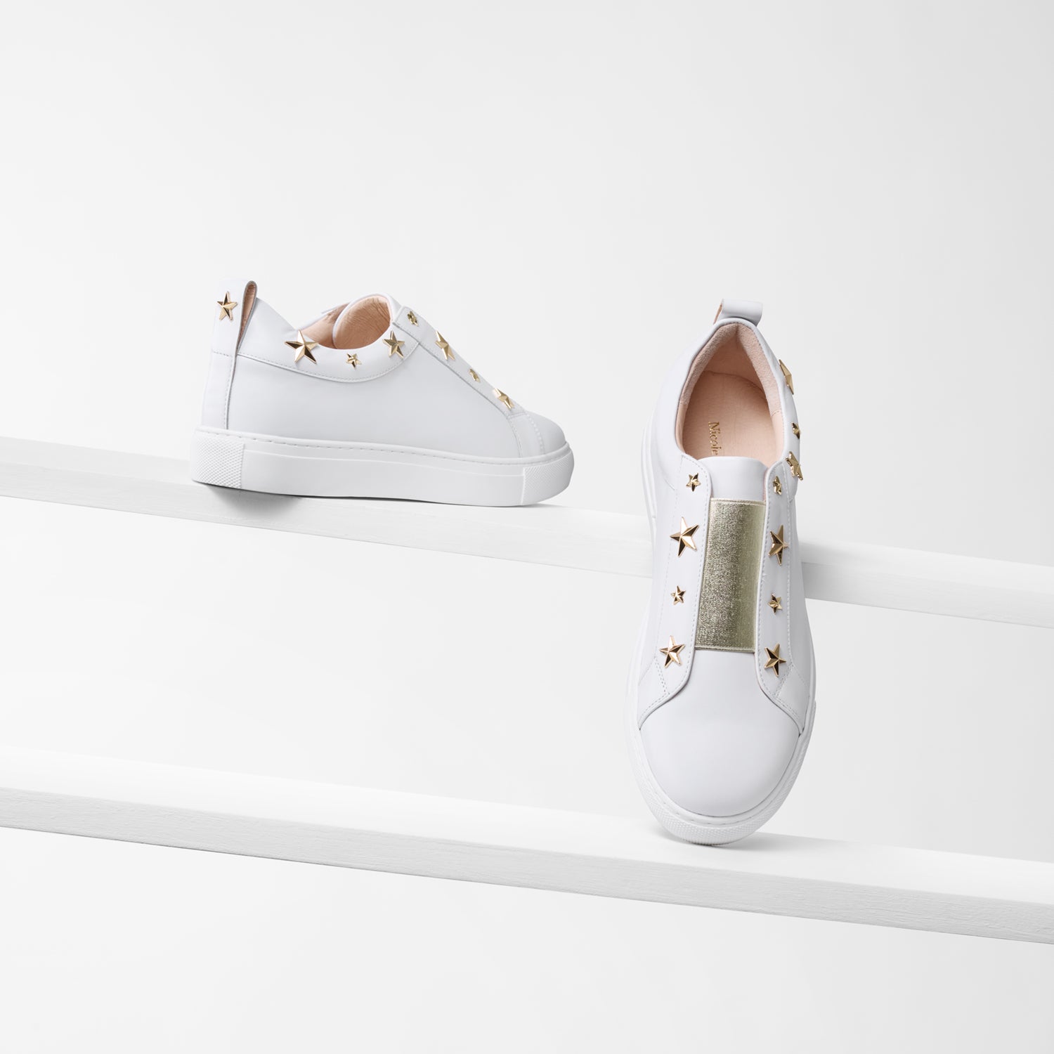 Felix white leather sneakers with gold star studs and gold elastic