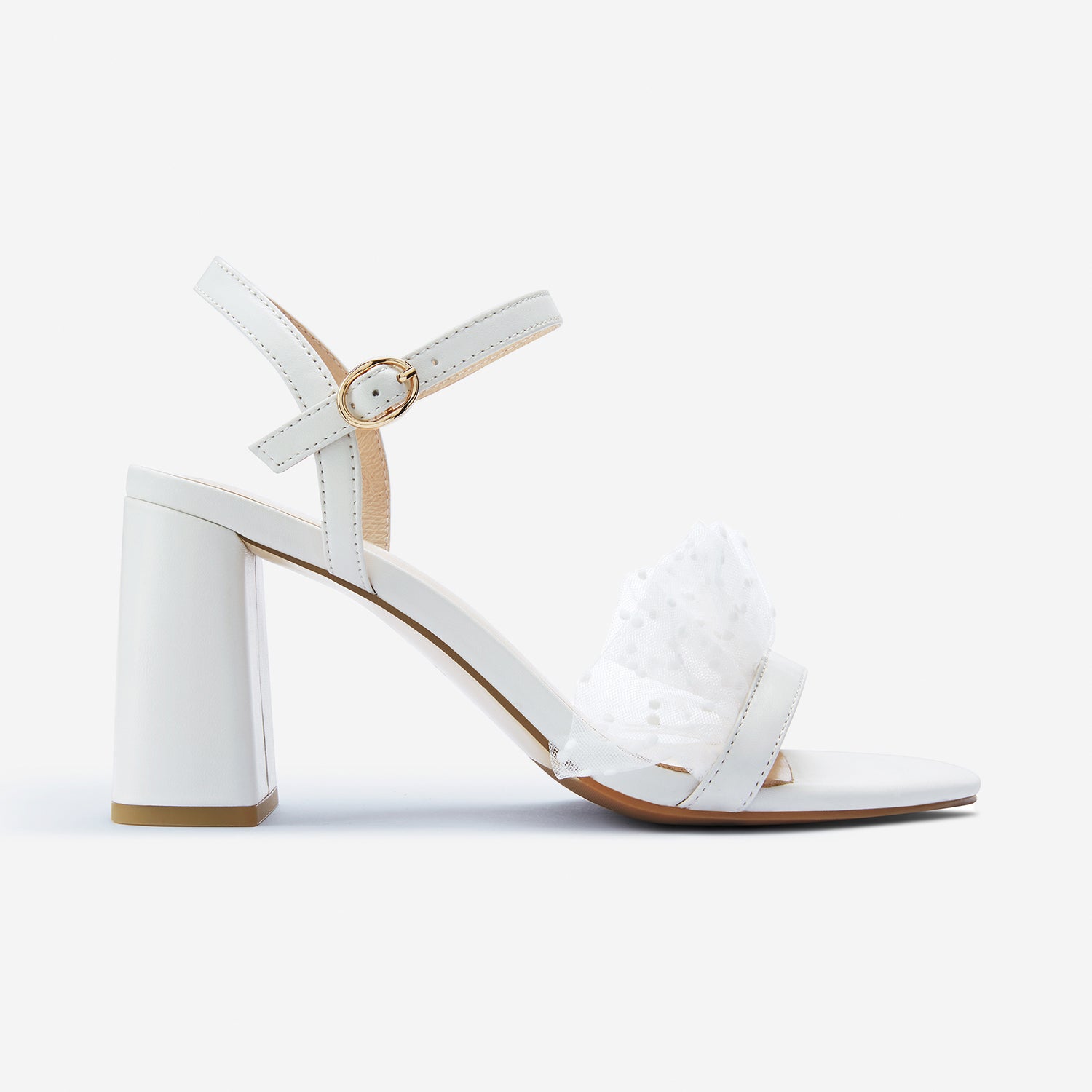 Freya off-white sandals with sheer polka dot fabric shown from the side. Block heel that is 8cm.