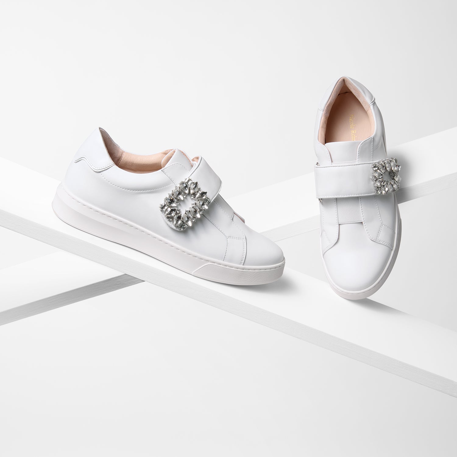Gracie white sneaker on planks showing full view.