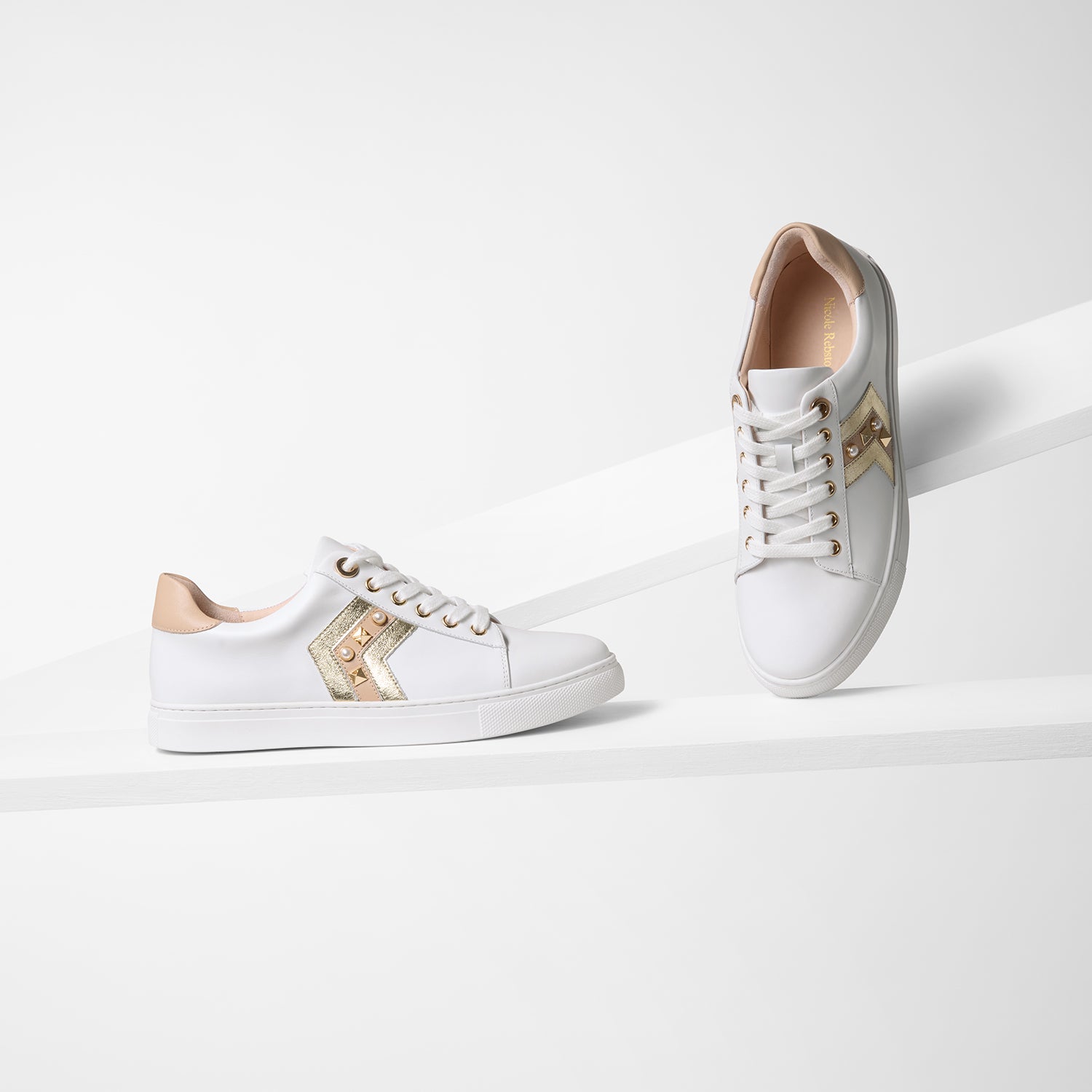 All angles of nude gold gray sneaker on planks.