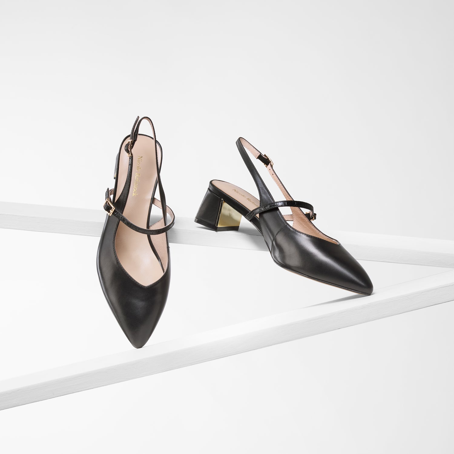 Black Harper Slingback shown from various angles with pointed toes, gold mirror heel detail and Mary Jane straps. Heel height is 5cm.
