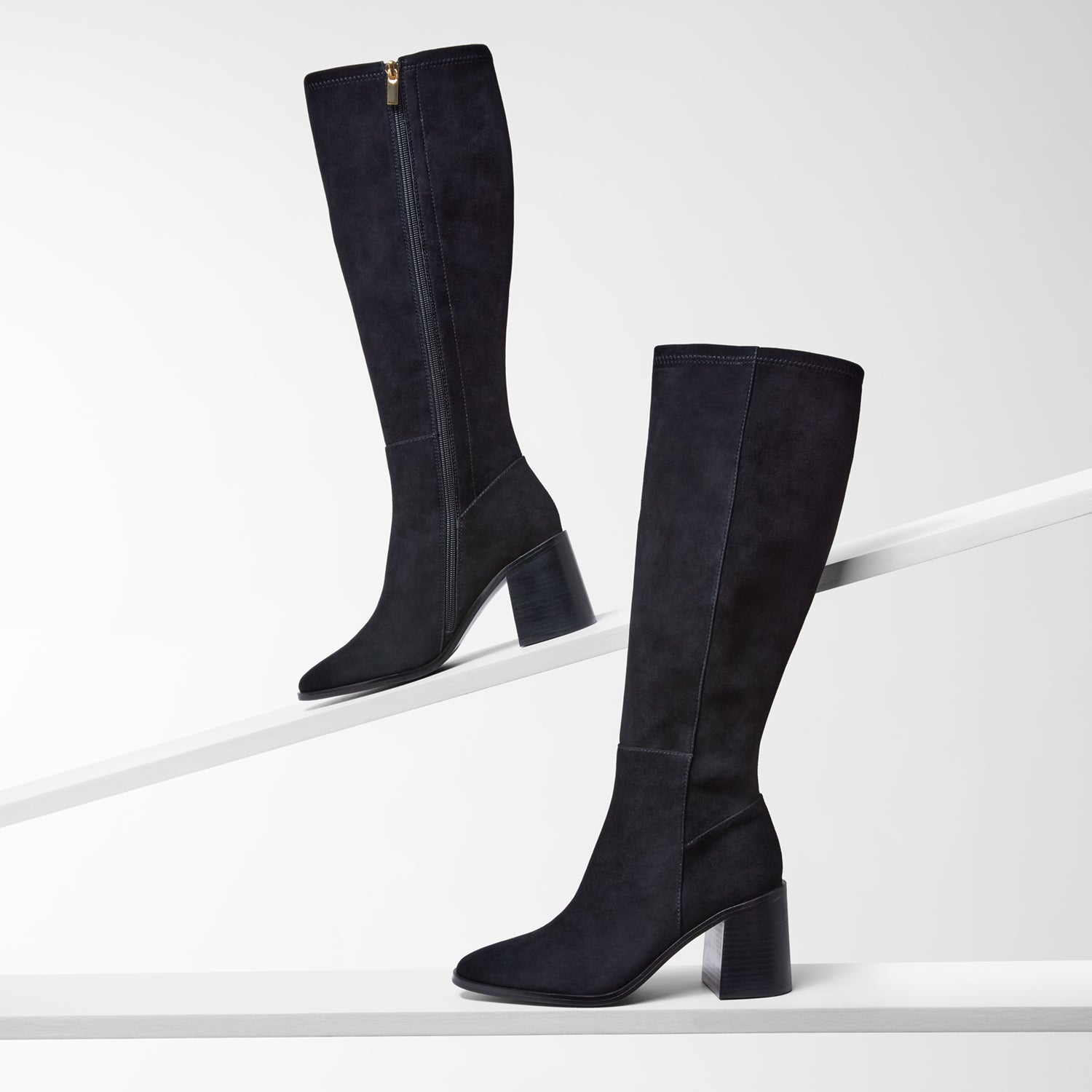 Pair of black knee-high boots on a white background. 8cm block heel and almond toe.