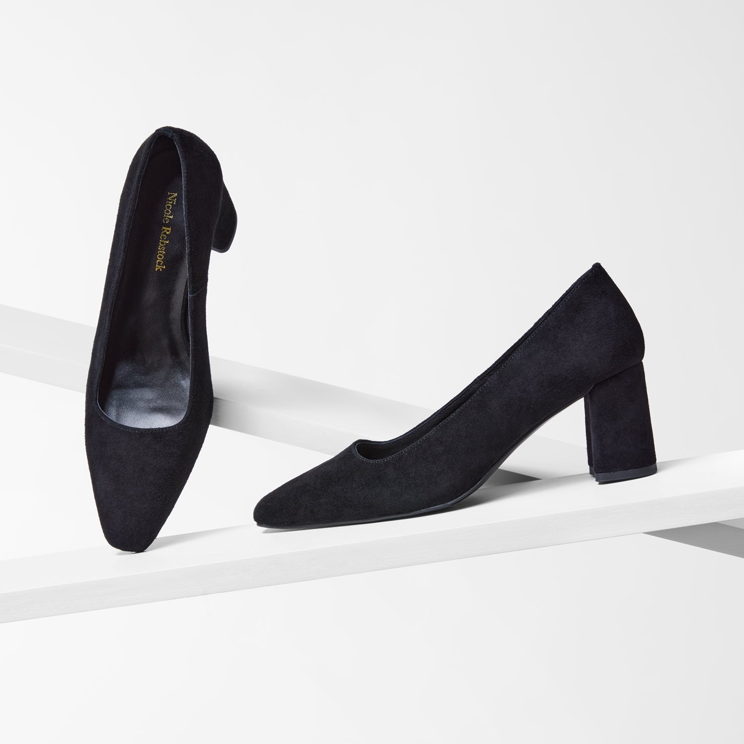 Black high-heeled shoes on a white background with square toe and block heel.