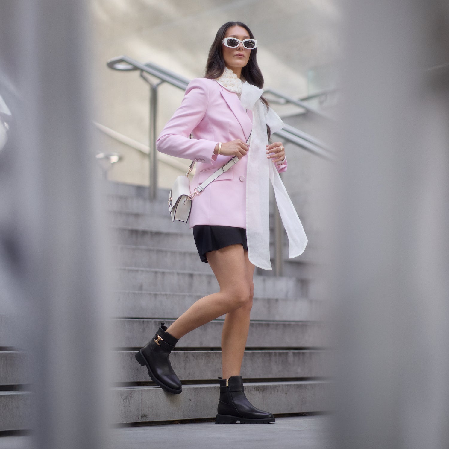 Woman wearing a pink coat and black Jaso boots by New Zealand Designer Nicole Rebstock.