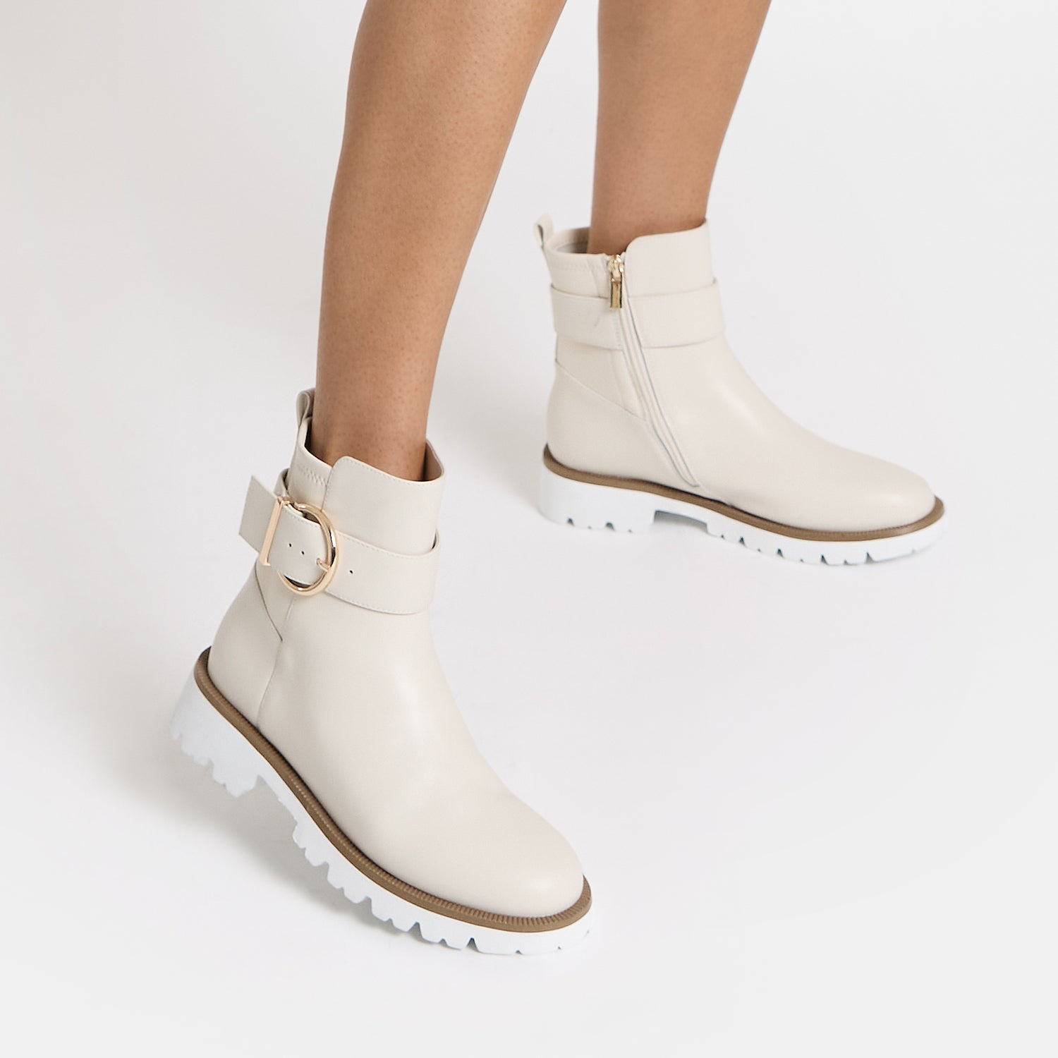 Jaxon ivory leather ankle boot on women's feet.