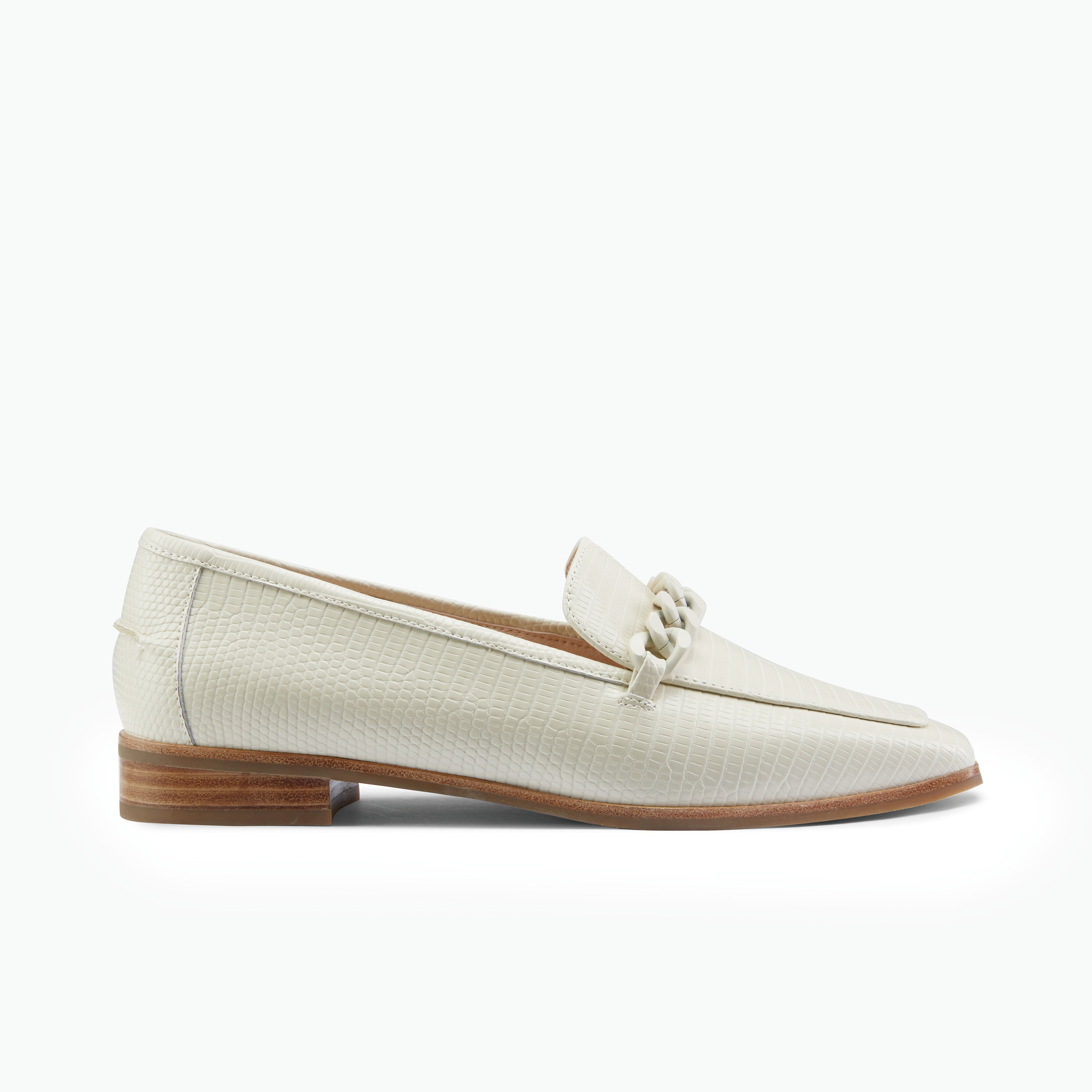 Pair of ivory loafers with a brown sole