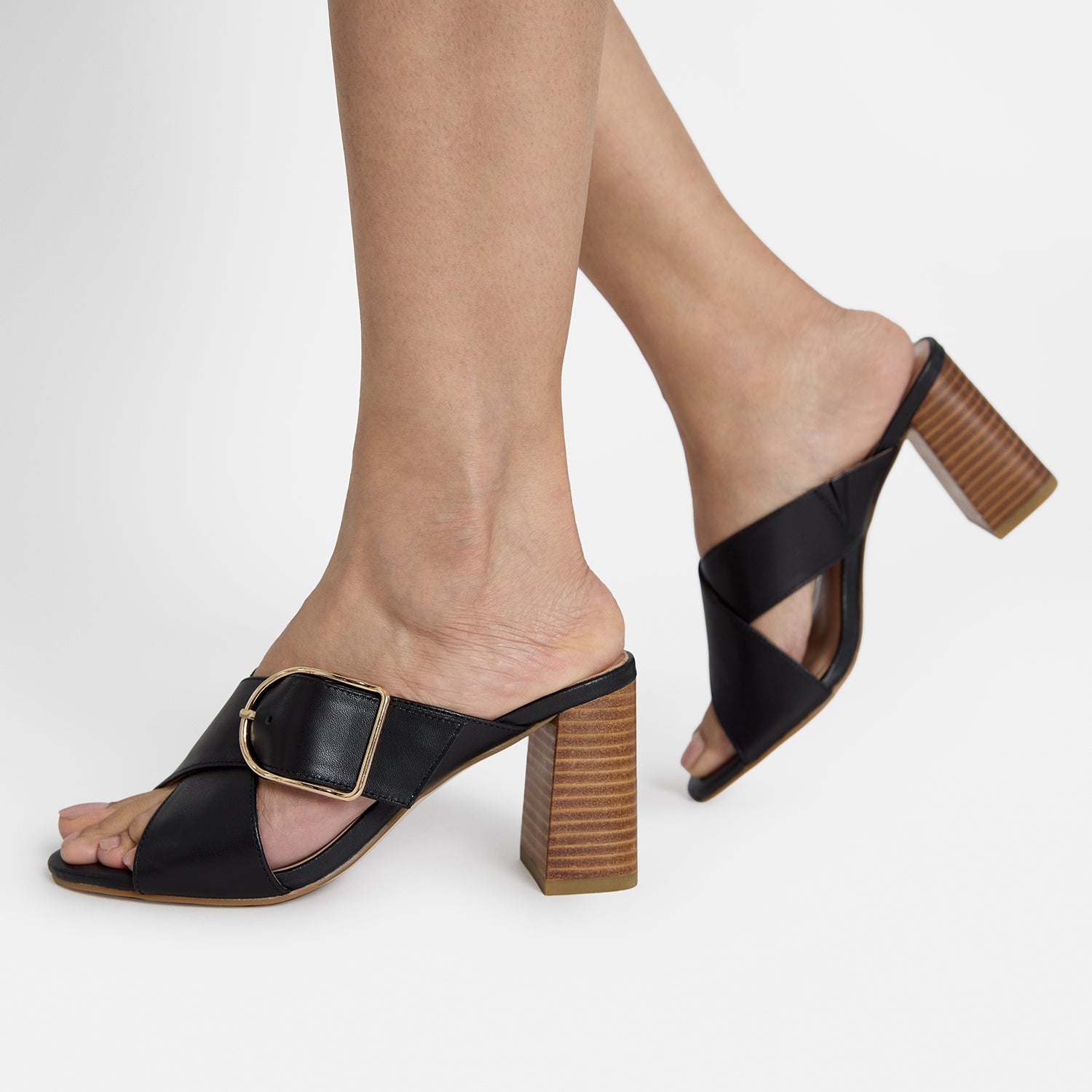 Kylie black leather sandal with 75mm heel on women's feet.