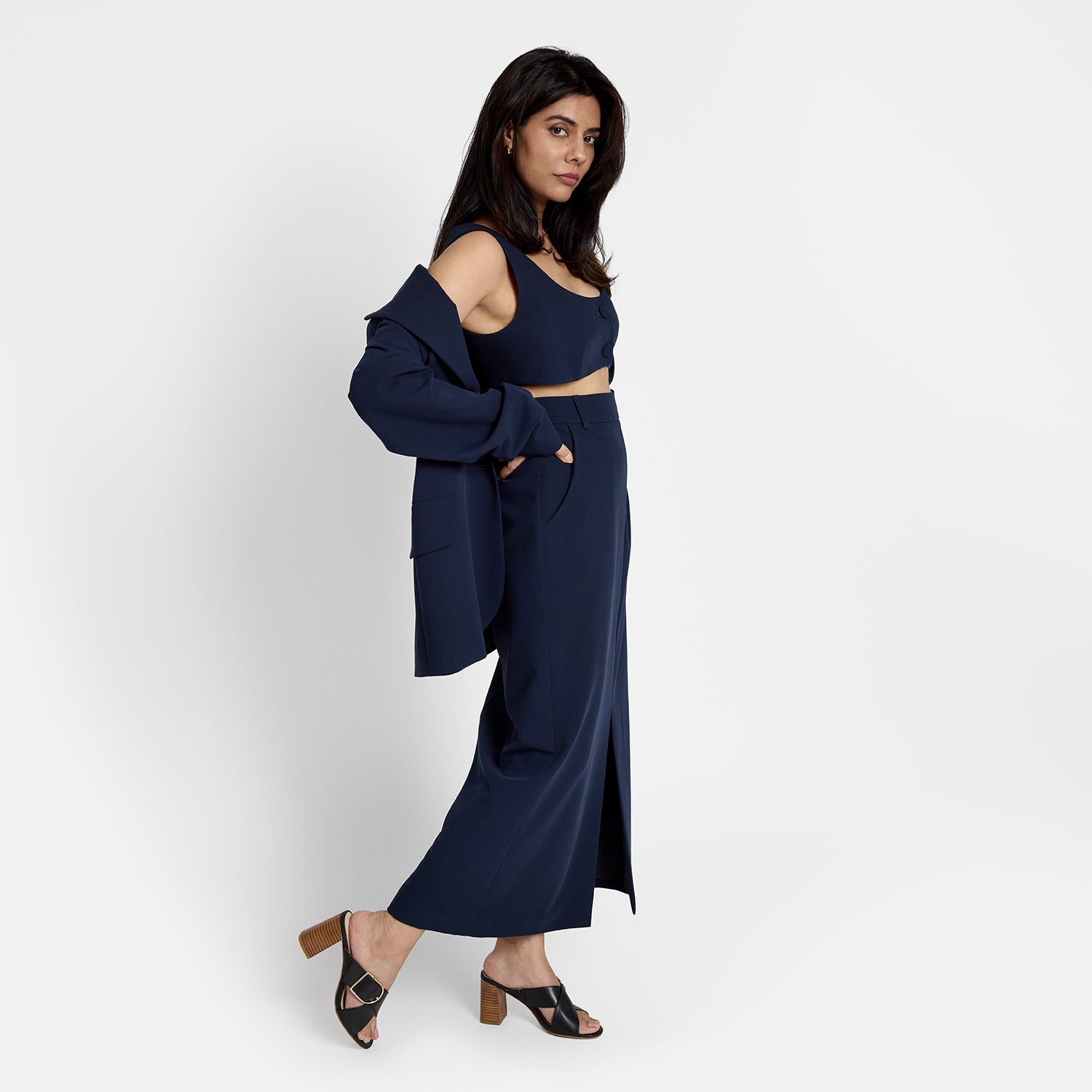 Kylie black leather sandal on model wearing navy top and long skirt.