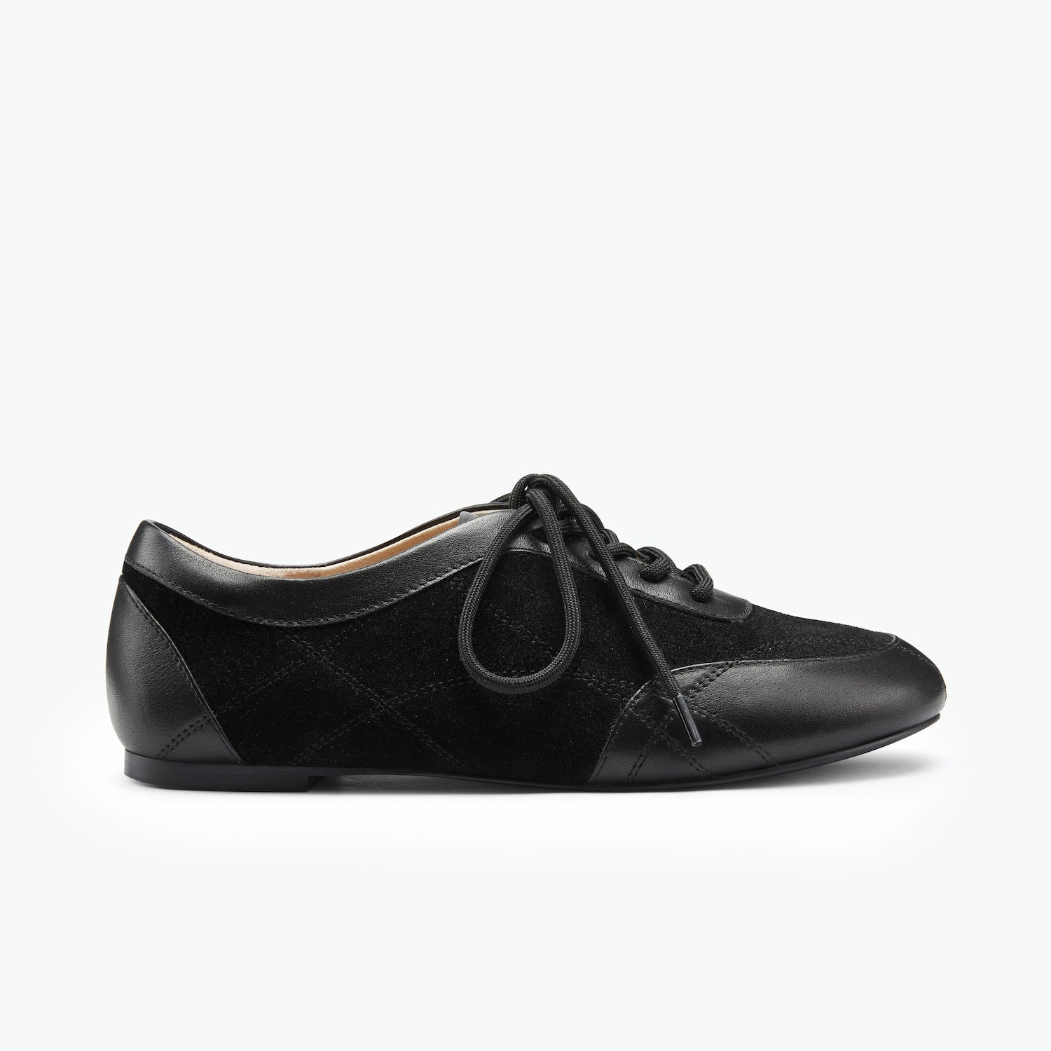 Black sneaker with quilted design on a white background