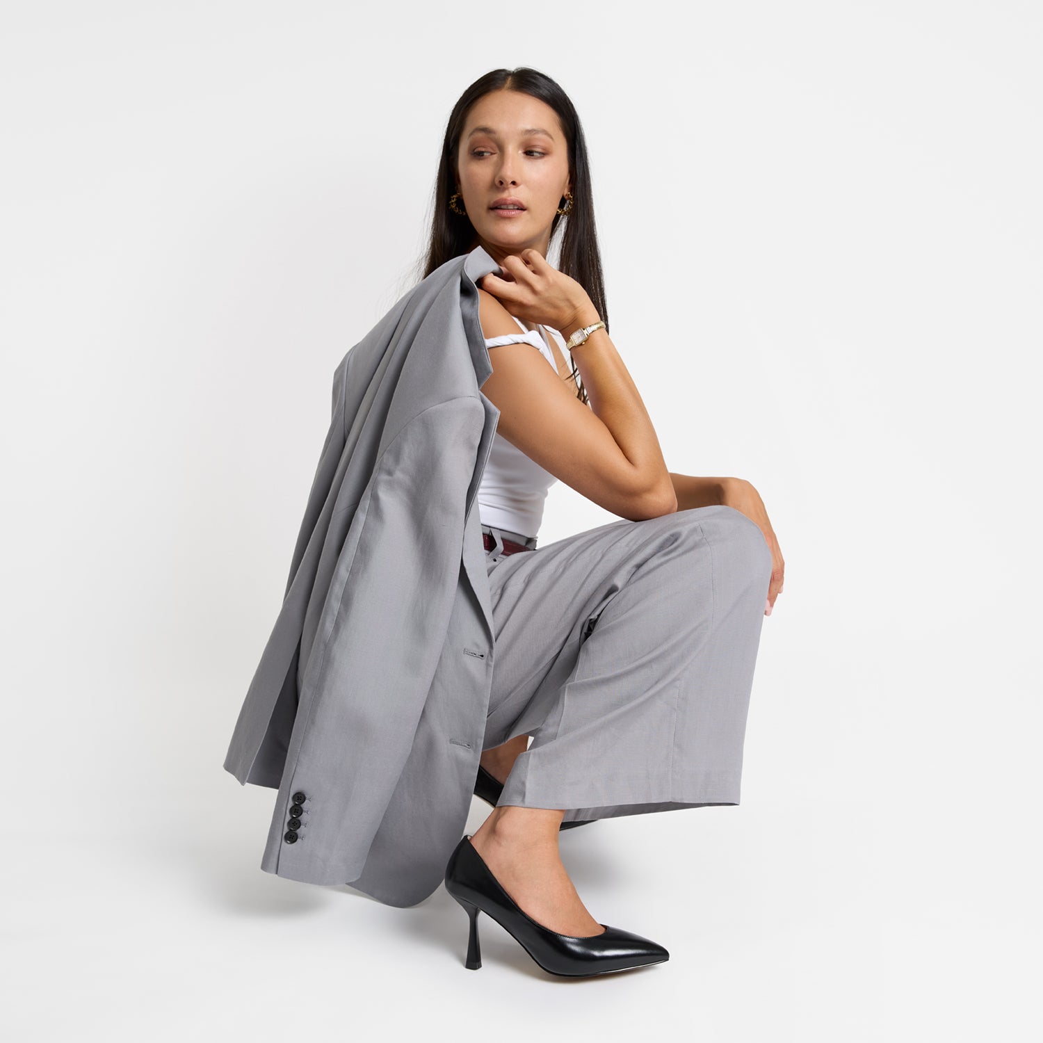 Lisbon black pump shown on model wearing a suit.