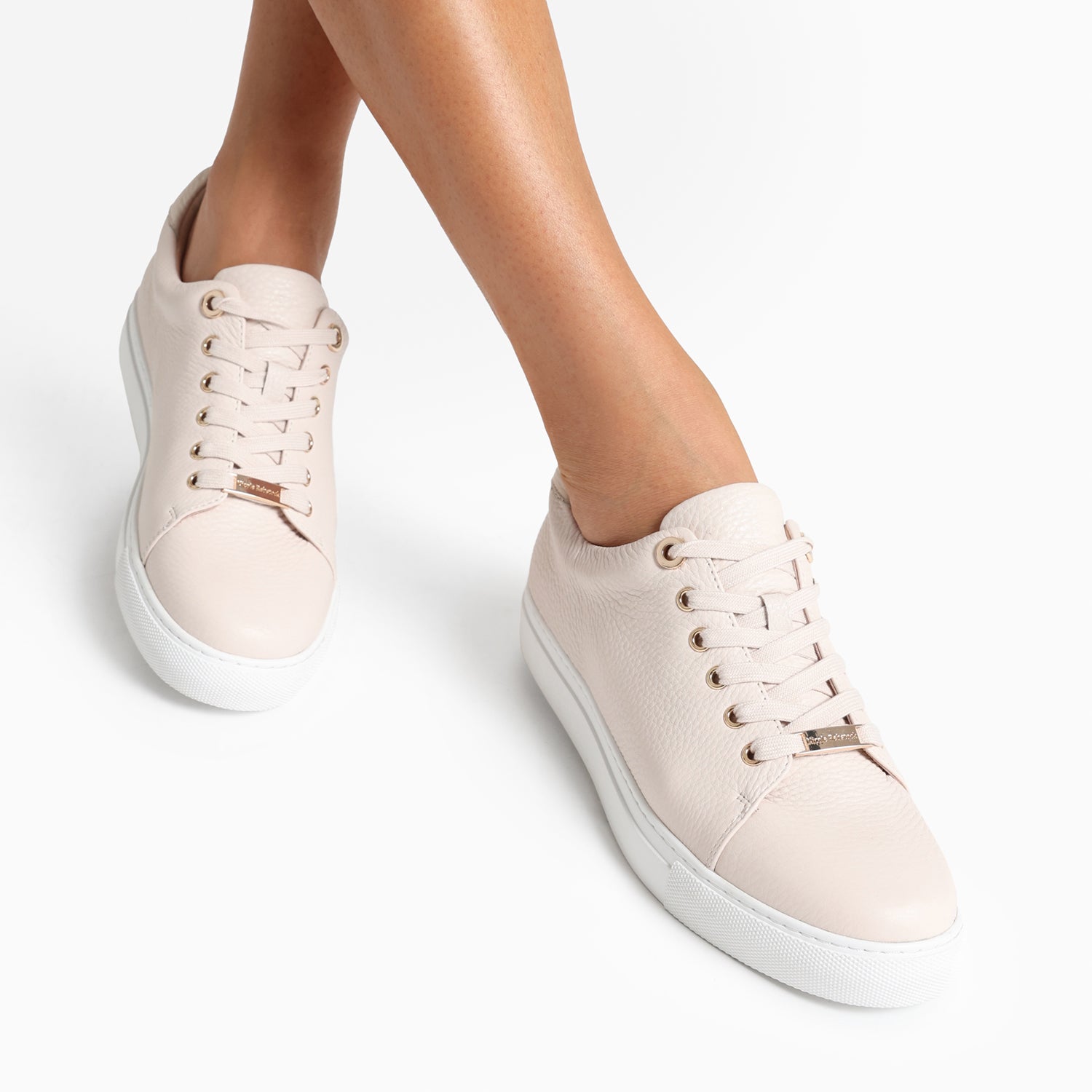 Up close shot of blush pebble sneaker, Mace, worn by woman.