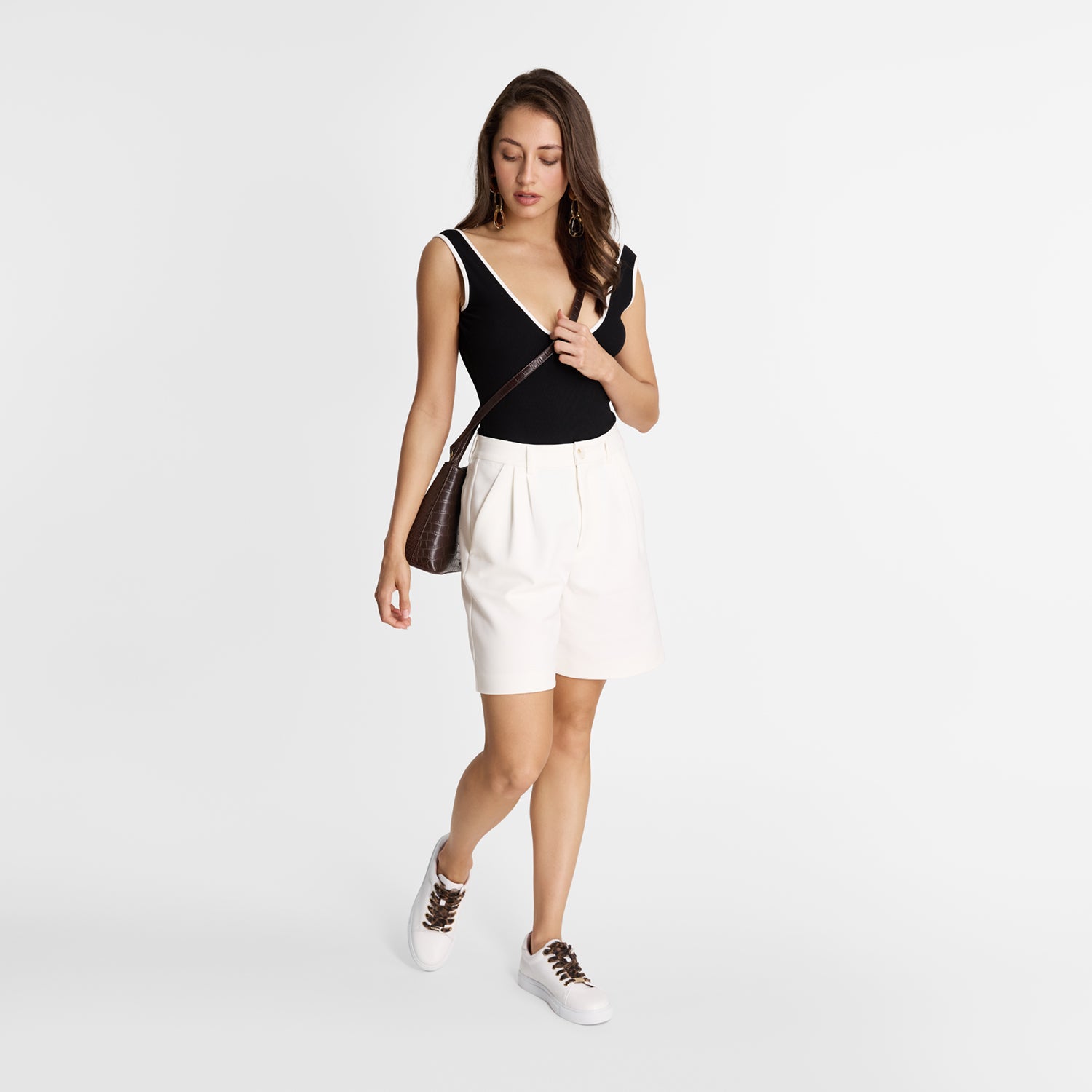 model wearing Ncole Rebstock Mace sneakers in white with leopard print laces