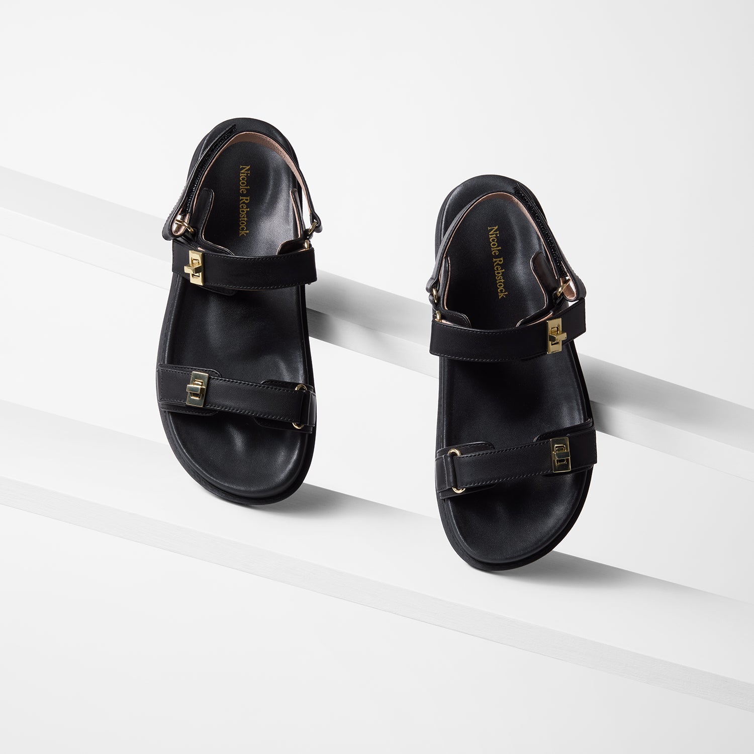 Upper view of Maine black flat sandal. They have a cushioned footbed for comfort.