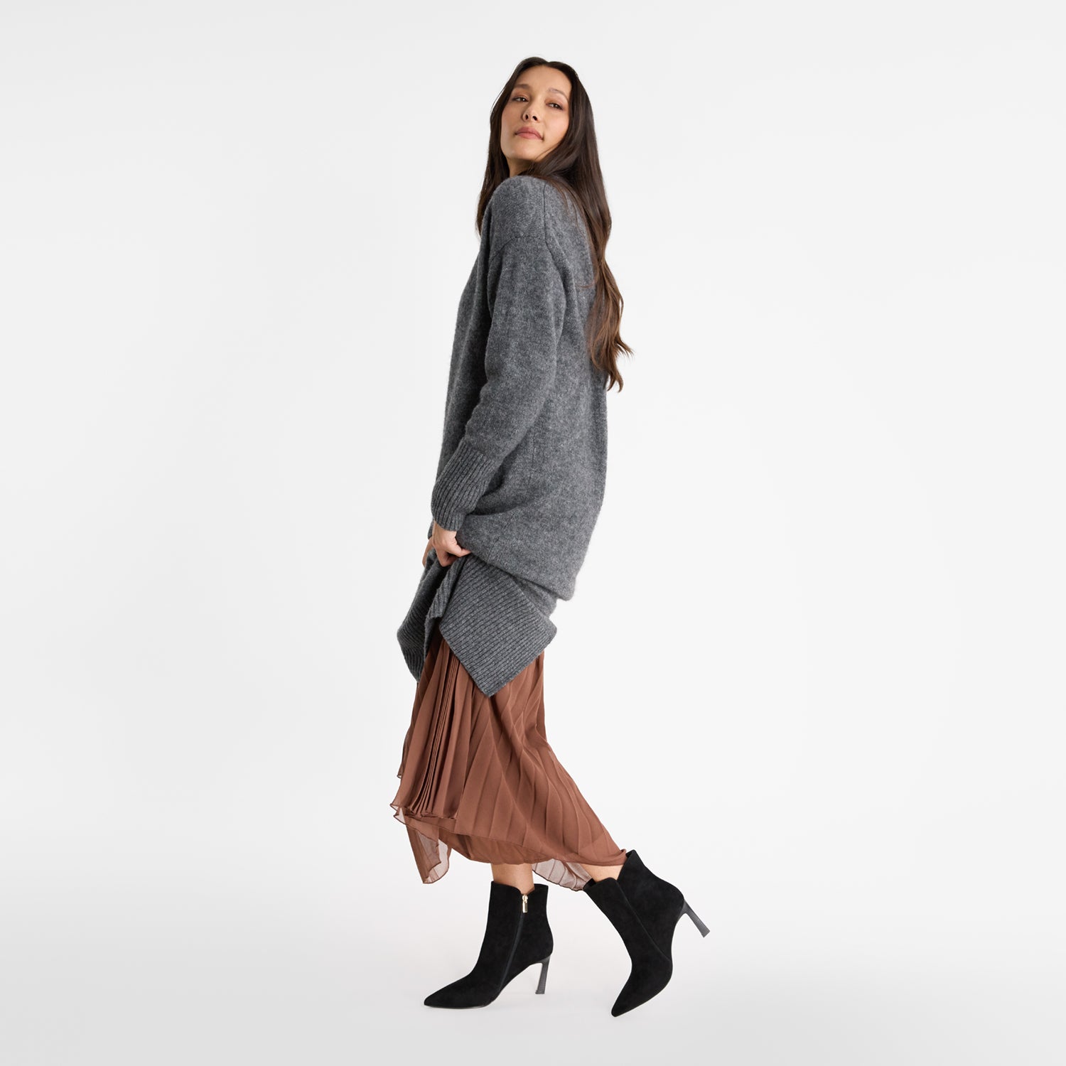 Model wearing Nicole Rebstock Mila ankle boot sin black suede with pointed toe and thin heel. 8.5cm heel.