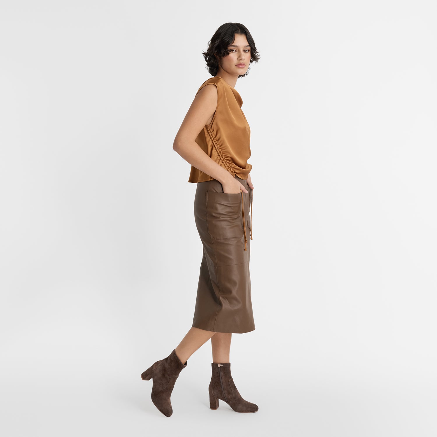 Model wearing Nicole Rebstock's Naomi ankle boots in chocolate brown suede