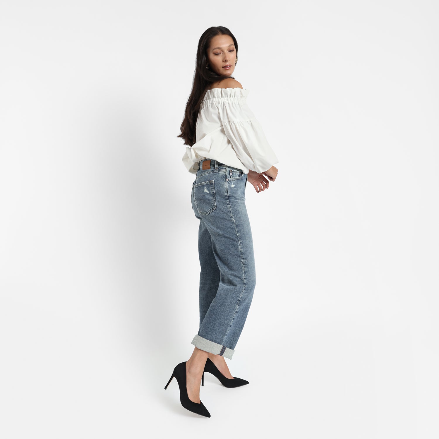 Naples black suede court shoe on model wearing baggy jeans and a white blouse.