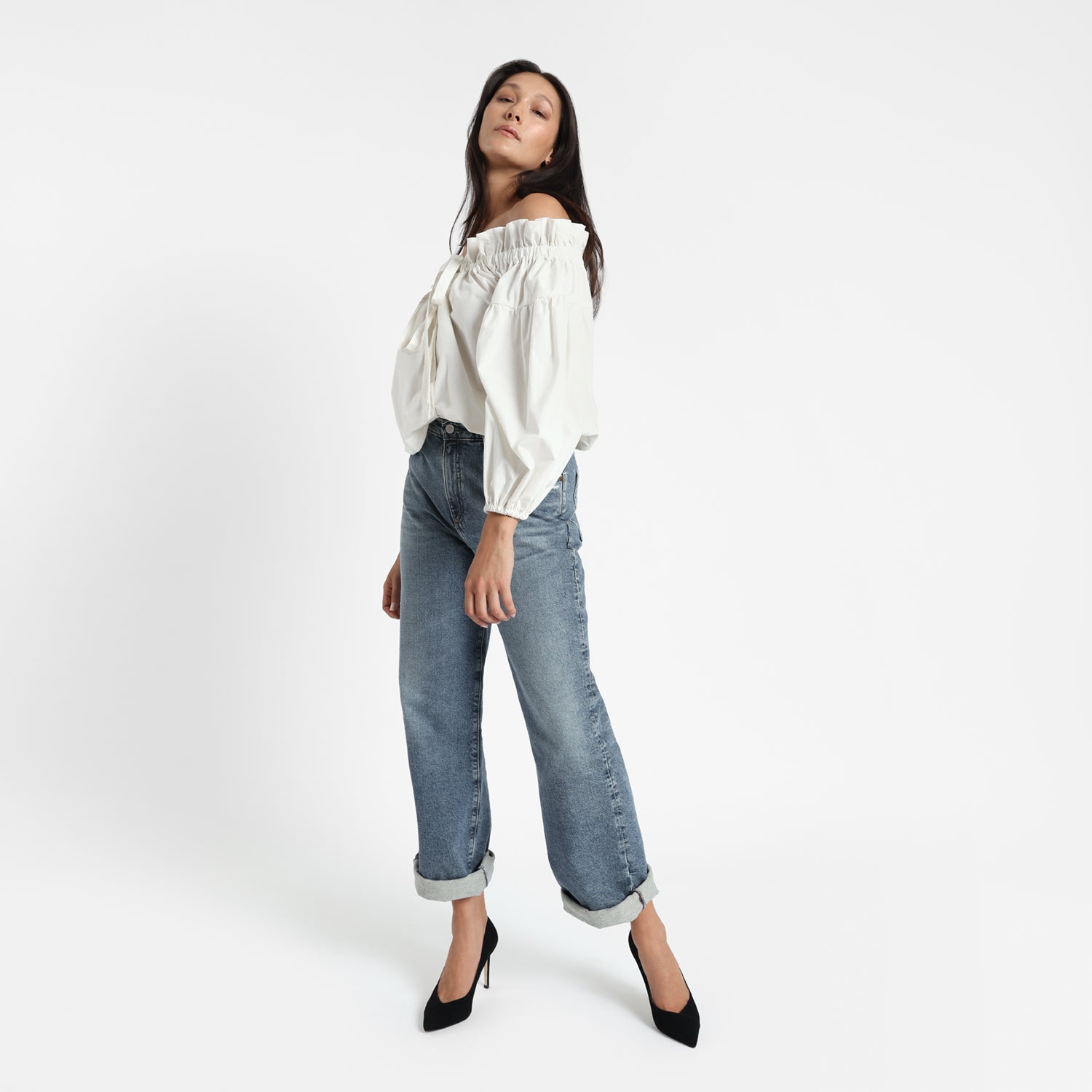 Naples black suede pump worn by model.