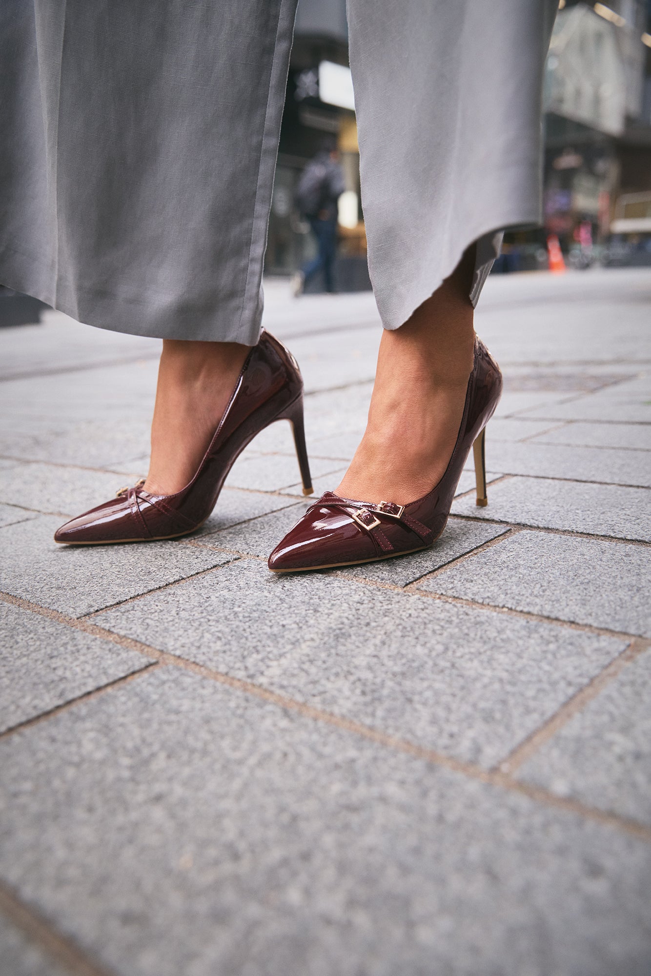 Nash pinot noir patent court shoe close up on women's feet.