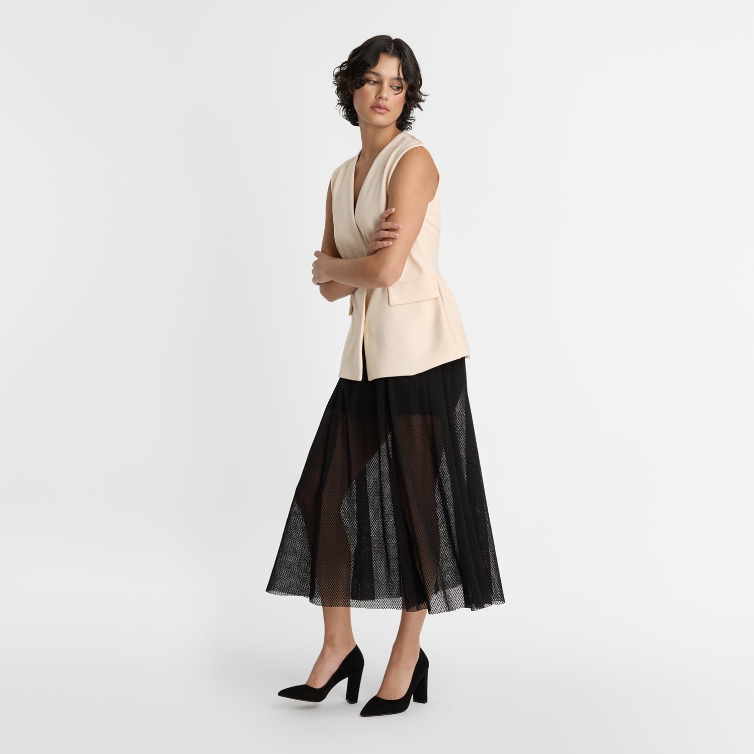 Model wearing Nicole Rebstock's suede leather pointed pumps with a 9.5cm block heel.