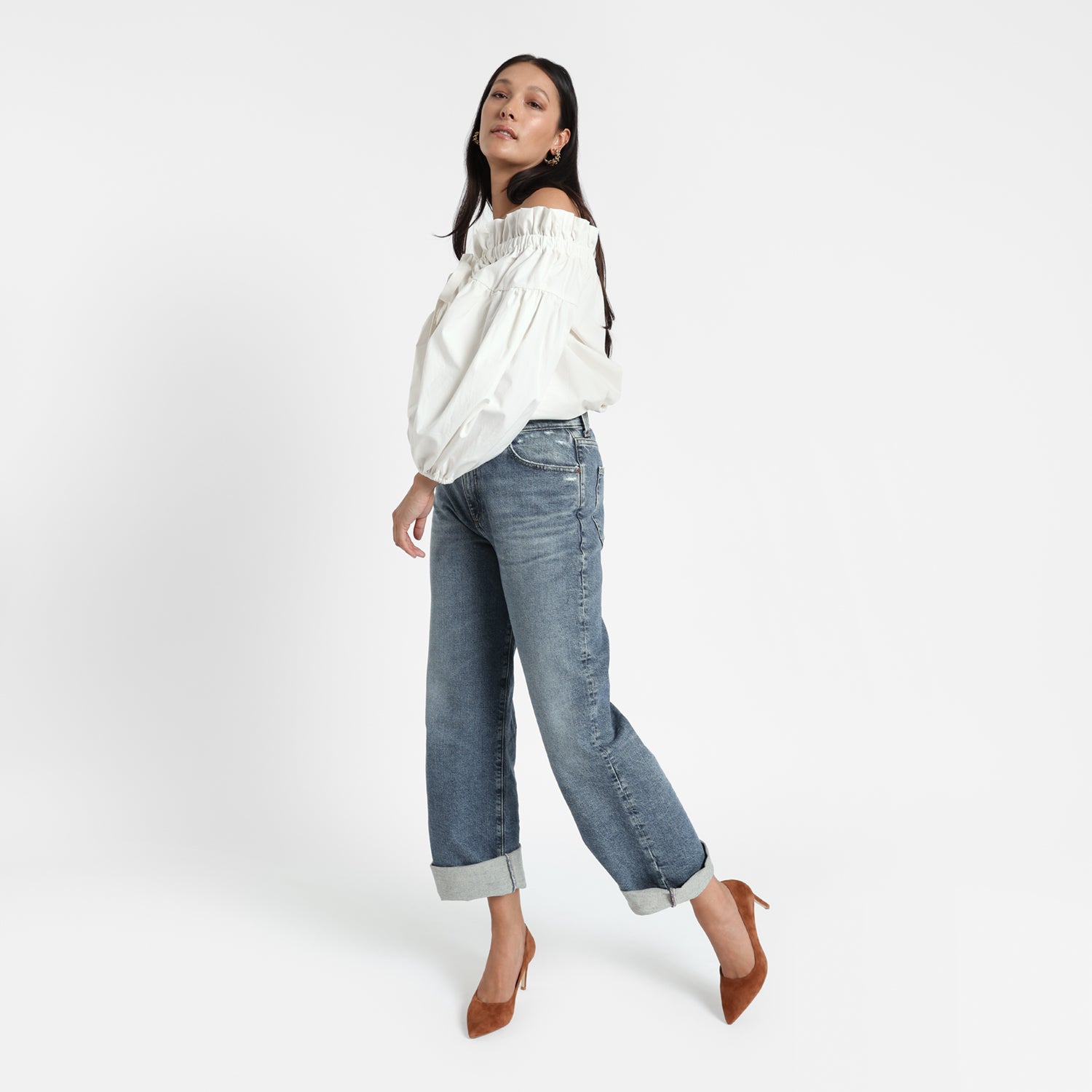 Nemesis rust suede court shoe on model wearing jeans and a puffy blouse.