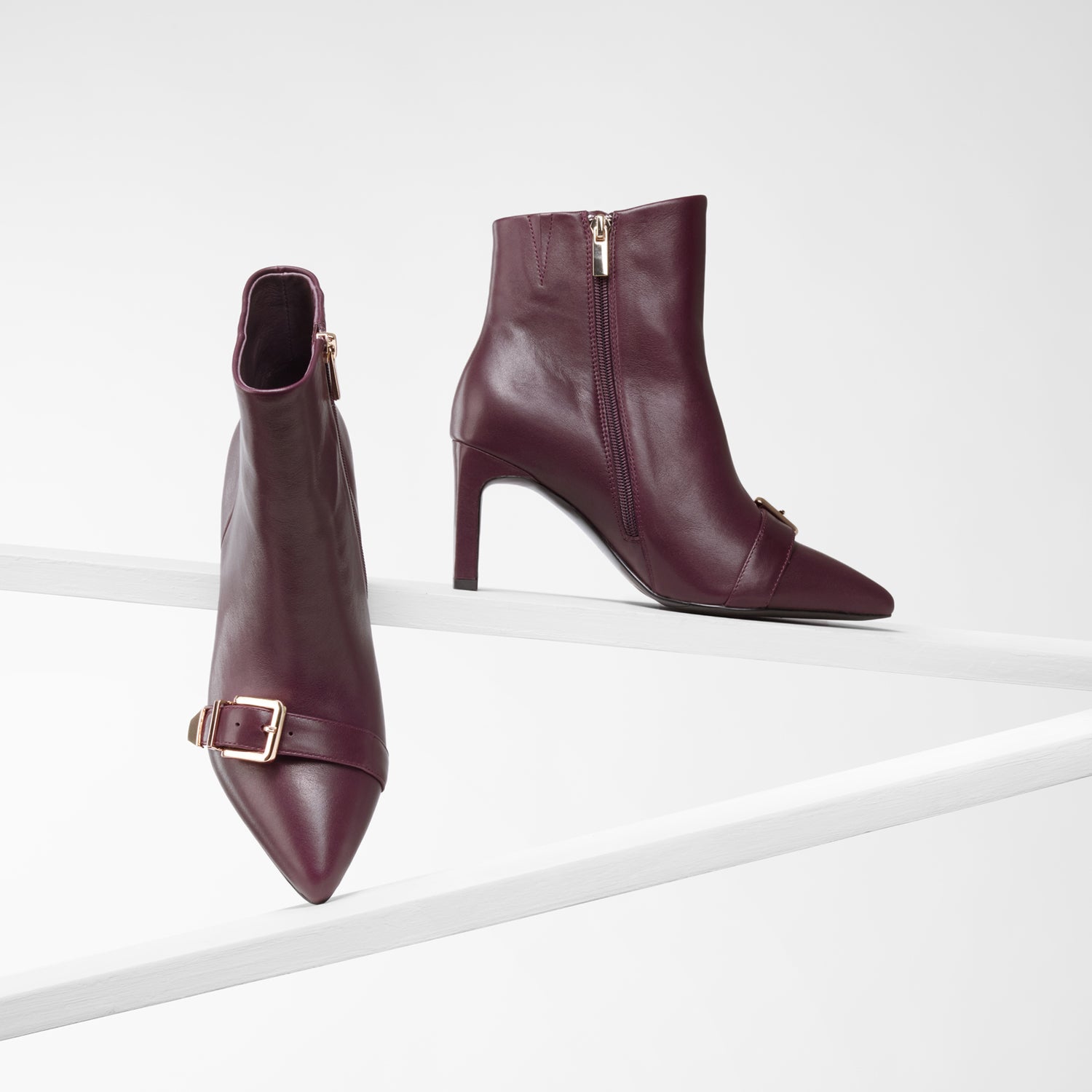 Various views of Rome Ankle Boots in Oxblood. 7.5cm block heel. Pointed toe with gold metal buckles on toe.