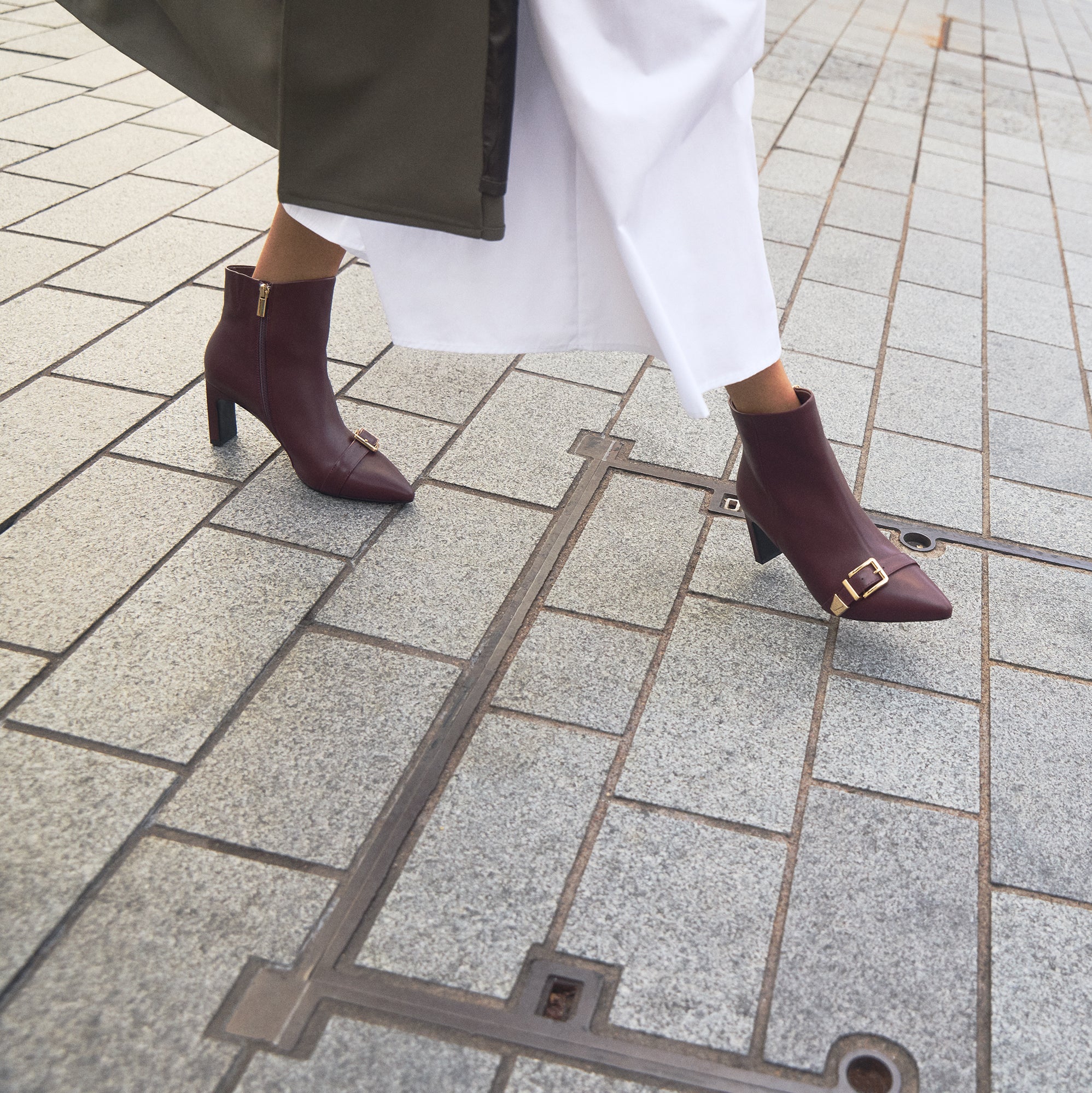 Woman wearing Rome Ox blood ankle boots. 75cm block heel.