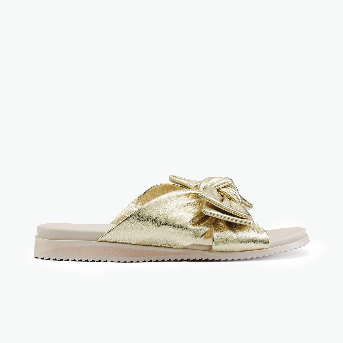 A single metallic gold slide sandal with a knotted bow detail across the top, set against a plain white background.