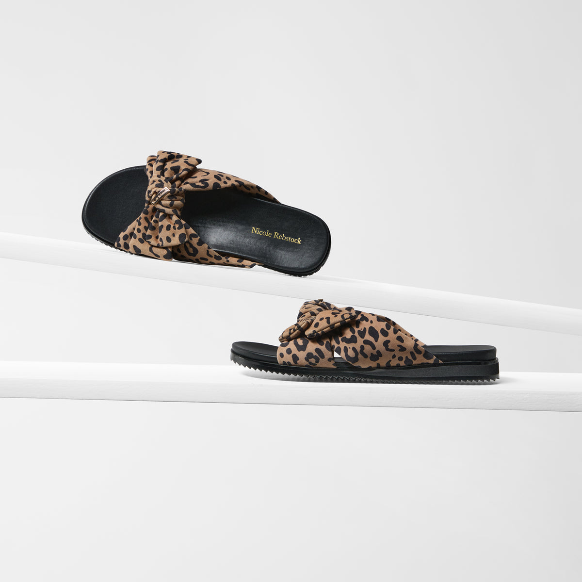 Salma sandals by Nicole Rebstock. Black sole and leopard print suede upper with a bow.