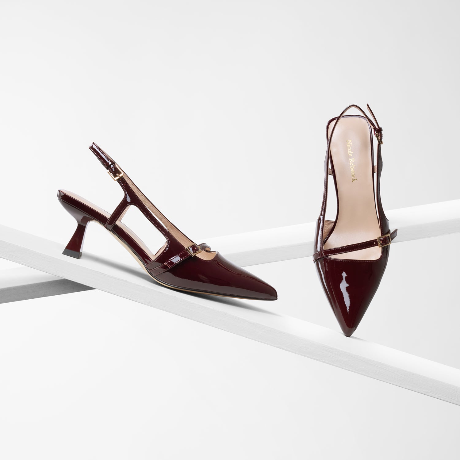 Sevilla pointed slingback in pinot noir patent on planks showing all angles