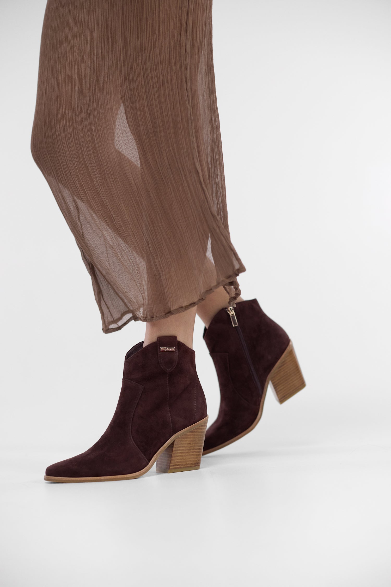 brown suede cowboy boots with block heel worn by model